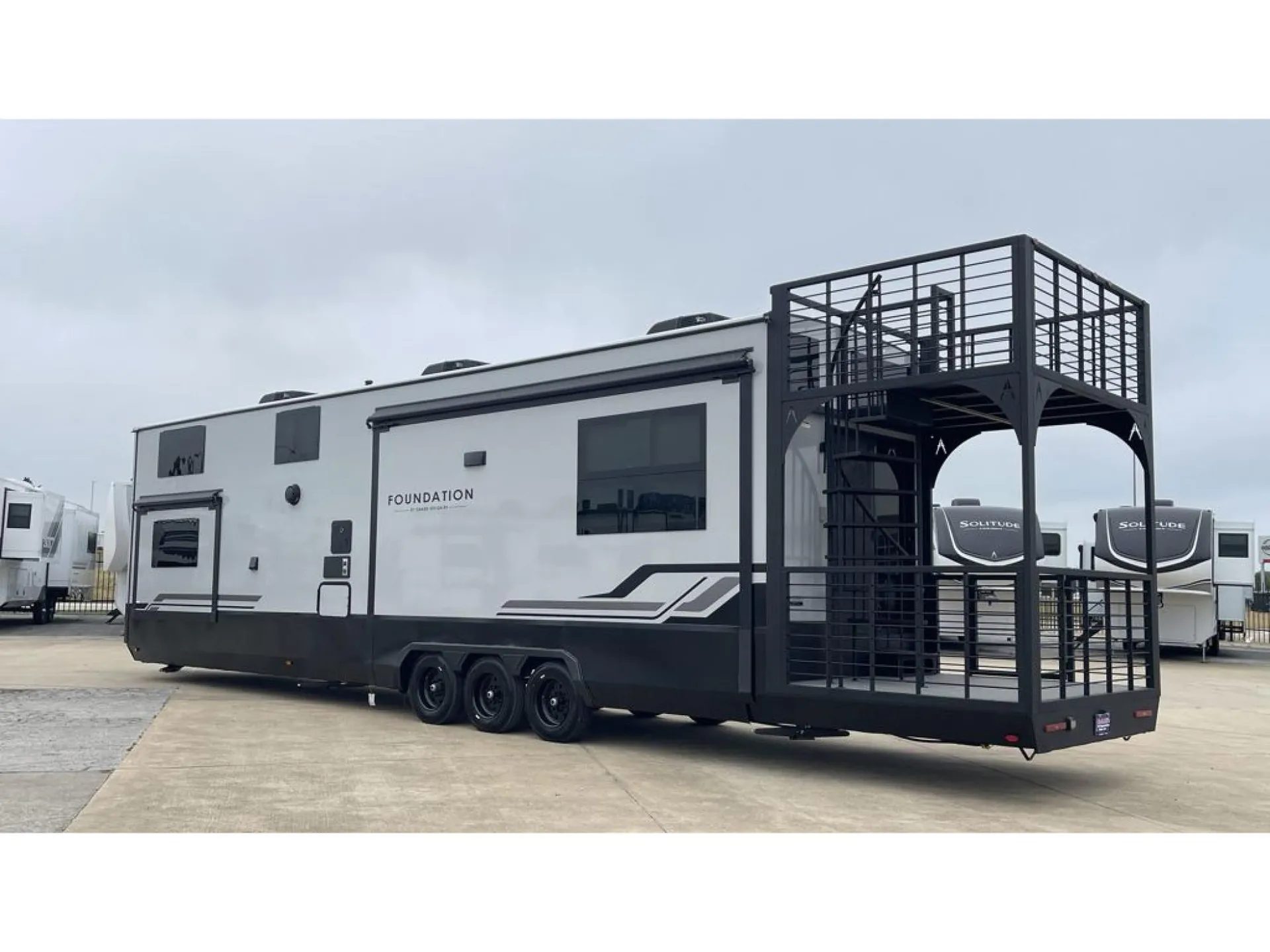 2026 Grand Design Foundation 42GD — Exterior three-quarter photograph prominently shows the RV shell, wheels, and large rear exterior deck and stairs