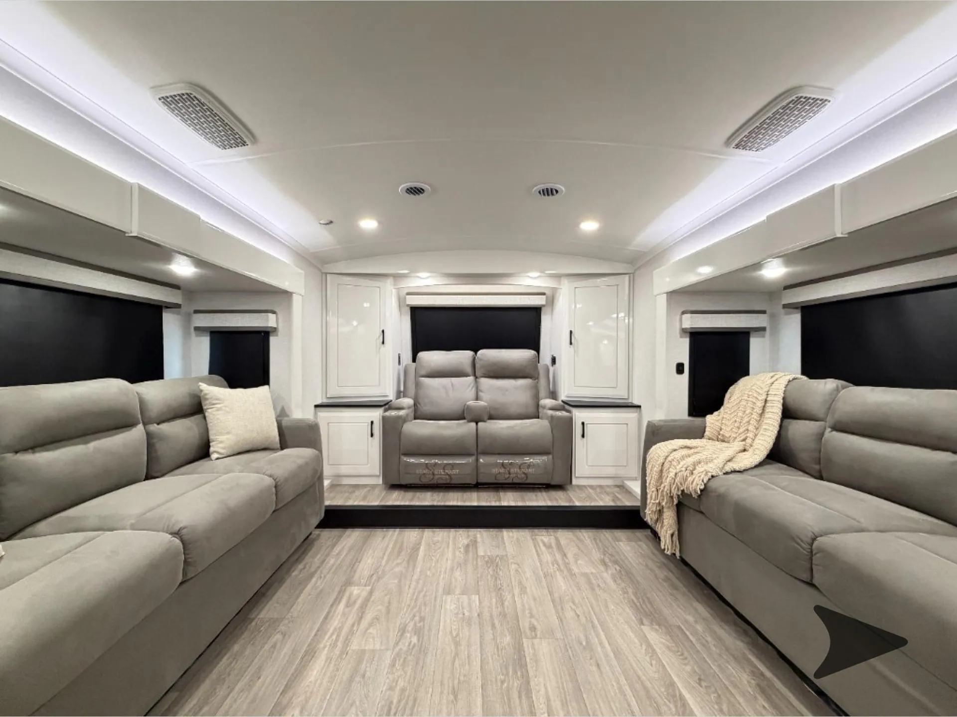 2027 Jayco Pinnacle 39FLOK — Fifth wheel living room with opposing sofas, centered dual recliners, windows, and overhead cabinetry