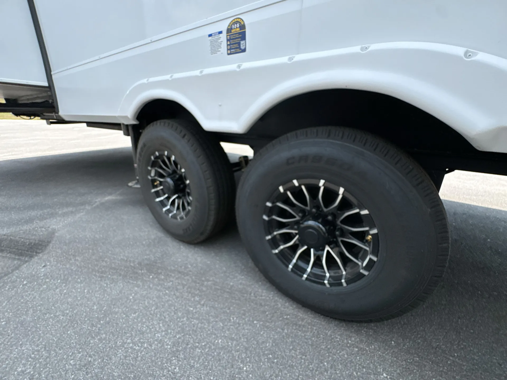 2026 Forest River Arctic Wolf 38LEAH.G — Visible exterior tandem wheels and wheel wells of the travel trailer