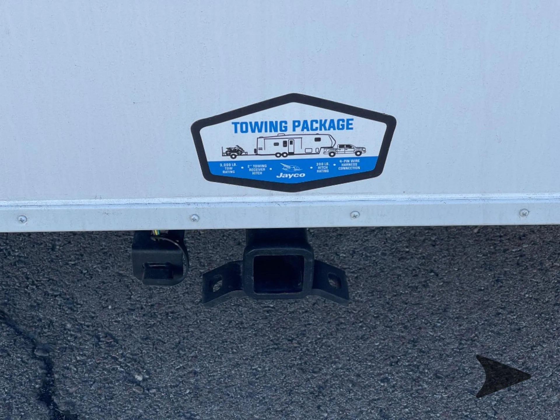 2027 Jayco Eagle 355MBQS — Exterior-installed towing hitch and towing-package label are visibly shown beneath the trailer