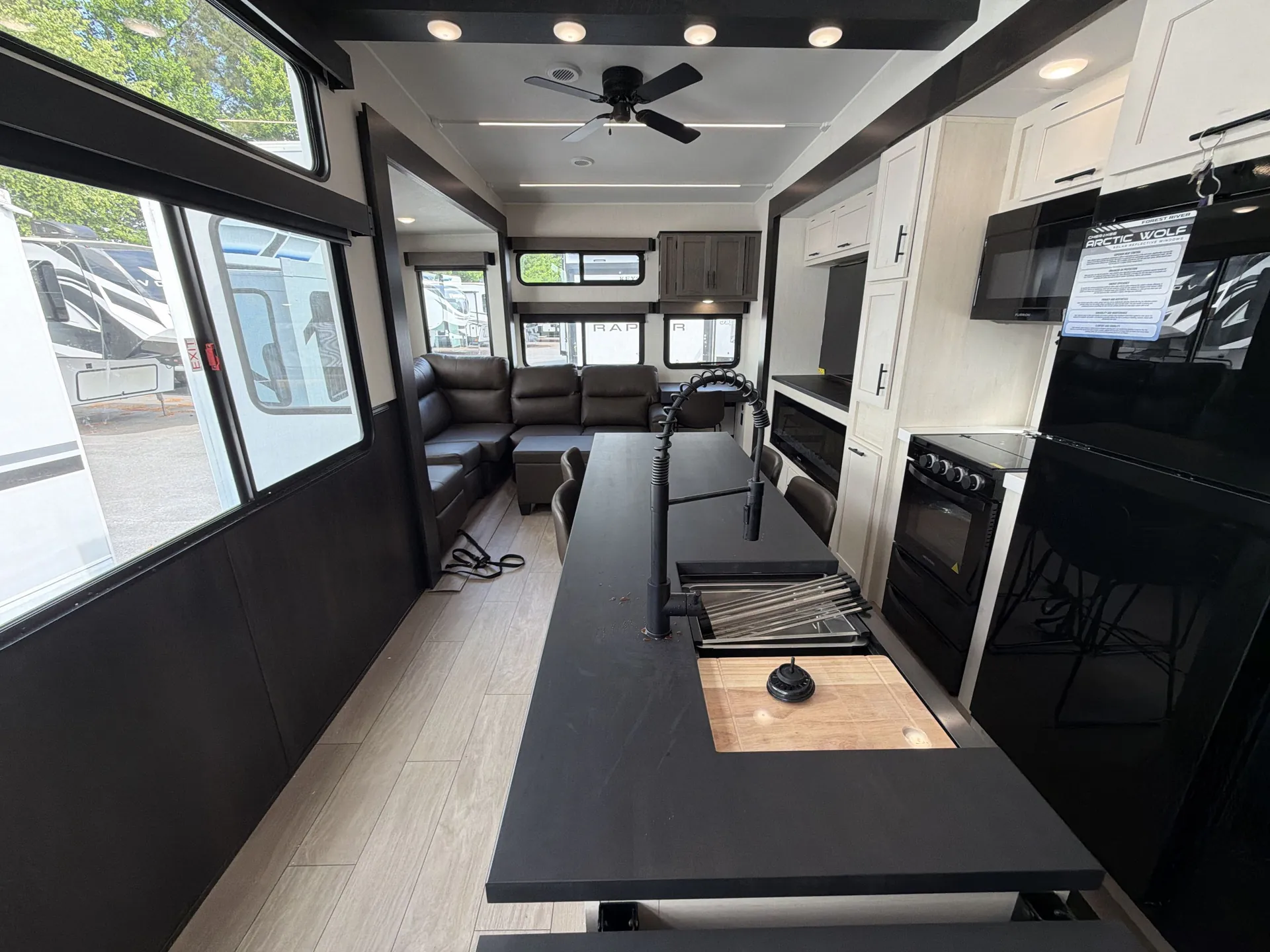 2026 Forest River Arctic Wolf 38LEAH.G — Fifth wheel kitchen island with sink and cooktop facing dining table and rear lounge seating