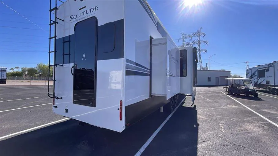 2026 Grand Design Solitude 391DL — Rear three-quarter photograph shows the physical RV exterior, rear wall, ladder, lights, and deployed slide-out