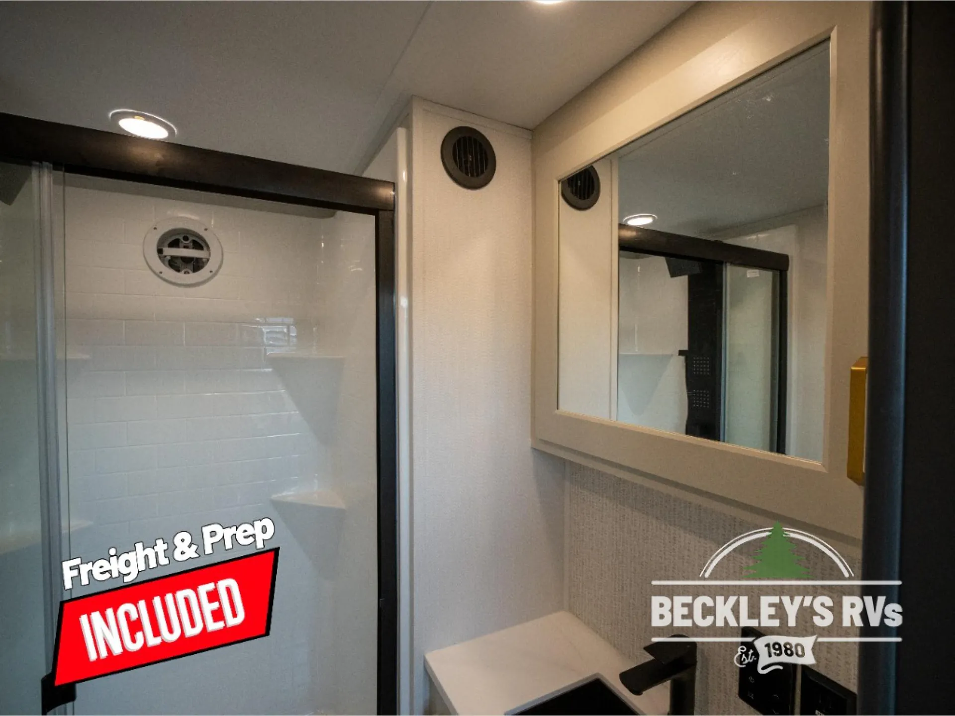 2026 Grand Design Foundation 42GD — Bathroom vanity with framed mirror beside a glass shower enclosure and visible shower fixtures