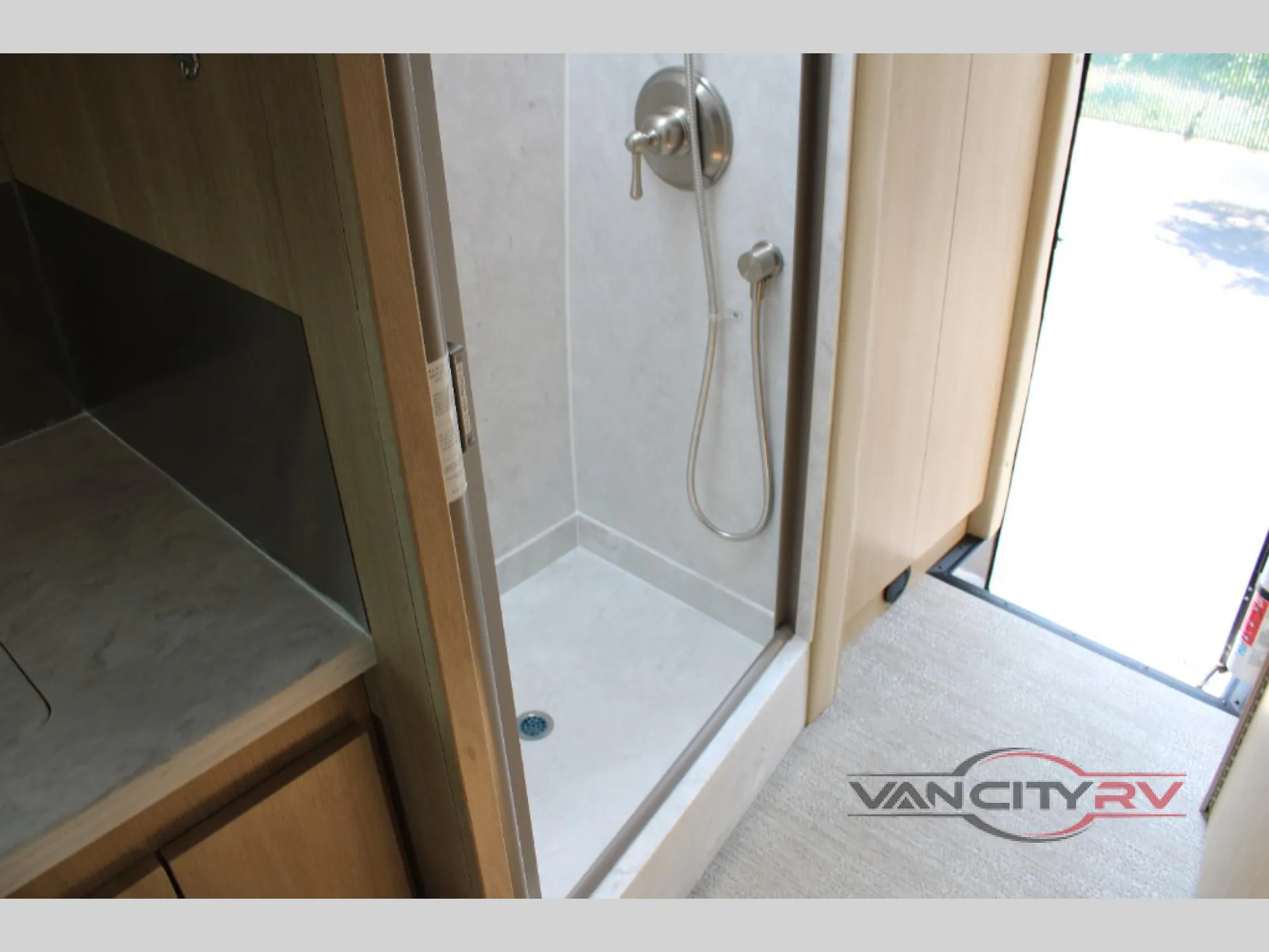 2025 Chinook RV Maverick SS — Class B van bathroom shower stall with handheld showerhead, controls, drain, and threshold