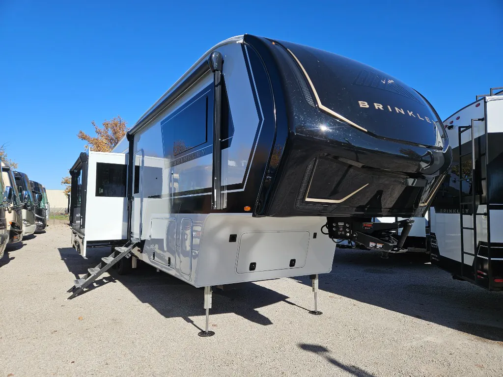 2026 Brinkley Model Z 3515 — Clearly shows the outside front and side of a Brinkley fifth-wheel RV, including its front cap, hitch, steps, and exterior body