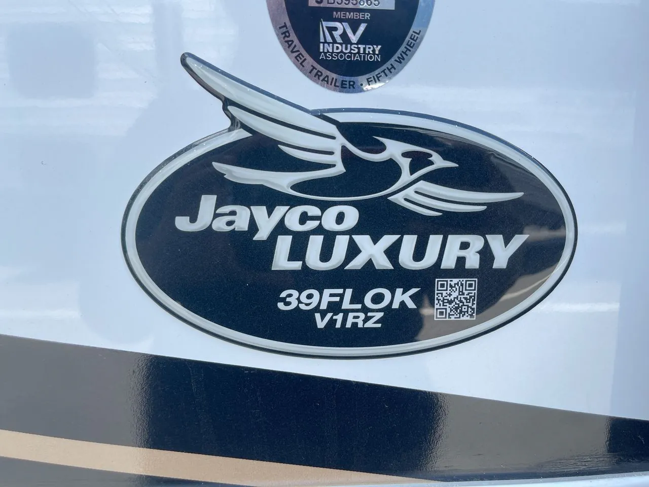 2027 Jayco Pinnacle 39FLOK — The RV's exterior Jayco Luxury 39FLOK badge mounted on the shell