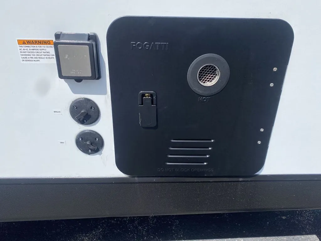 2026 Gulf Stream Vista Cruiser 19ERD — Exterior close-up showing the Fogatti water-heater/service panel and adjacent utility connections