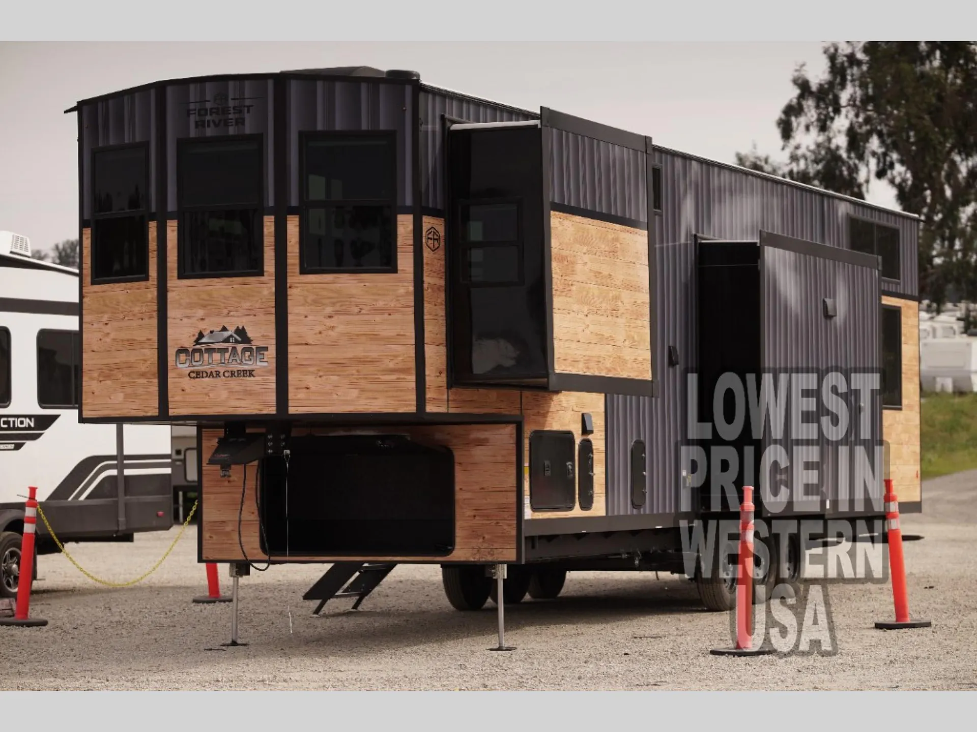 2026 Forest River Cedar Creek Cottage 41FWC — Visible rear/side exterior view shows the RV shell, slide-outs, windows, exterior doors, and landing gear