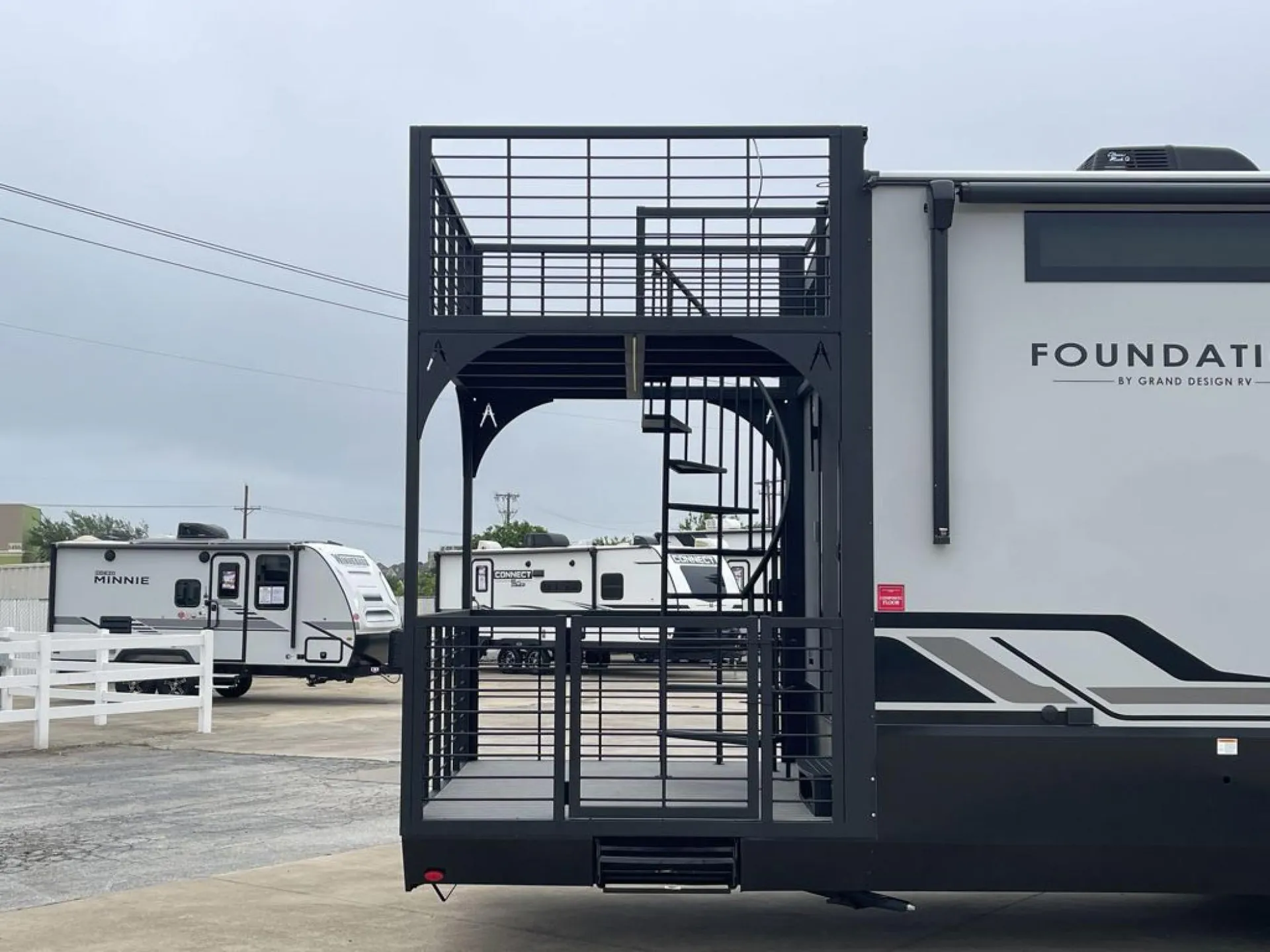 2026 Grand Design Foundation 42GD — Clear exterior photograph of the Foundation travel trailer, including its elevated deck and stairs
