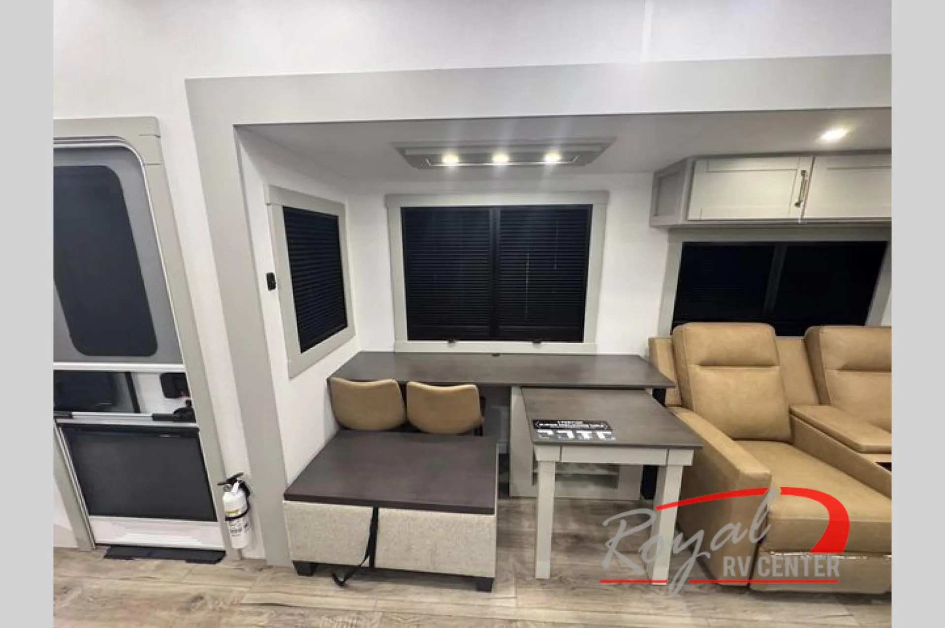 2026 Brinkley Model Z 3610 — Dinette with bench seating and table beside living-room recliners, with the entry door visible at left