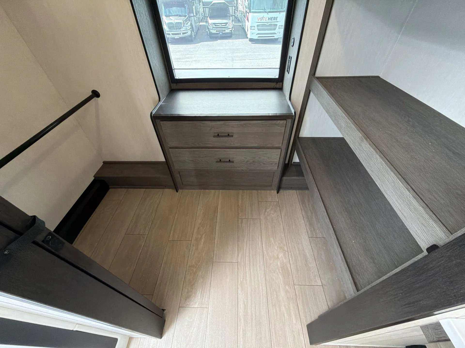 2026 Forest River Arctic Wolf 38LEAH.G — Elevated loft sleeping area with a dresser beneath a window and built-in side shelving