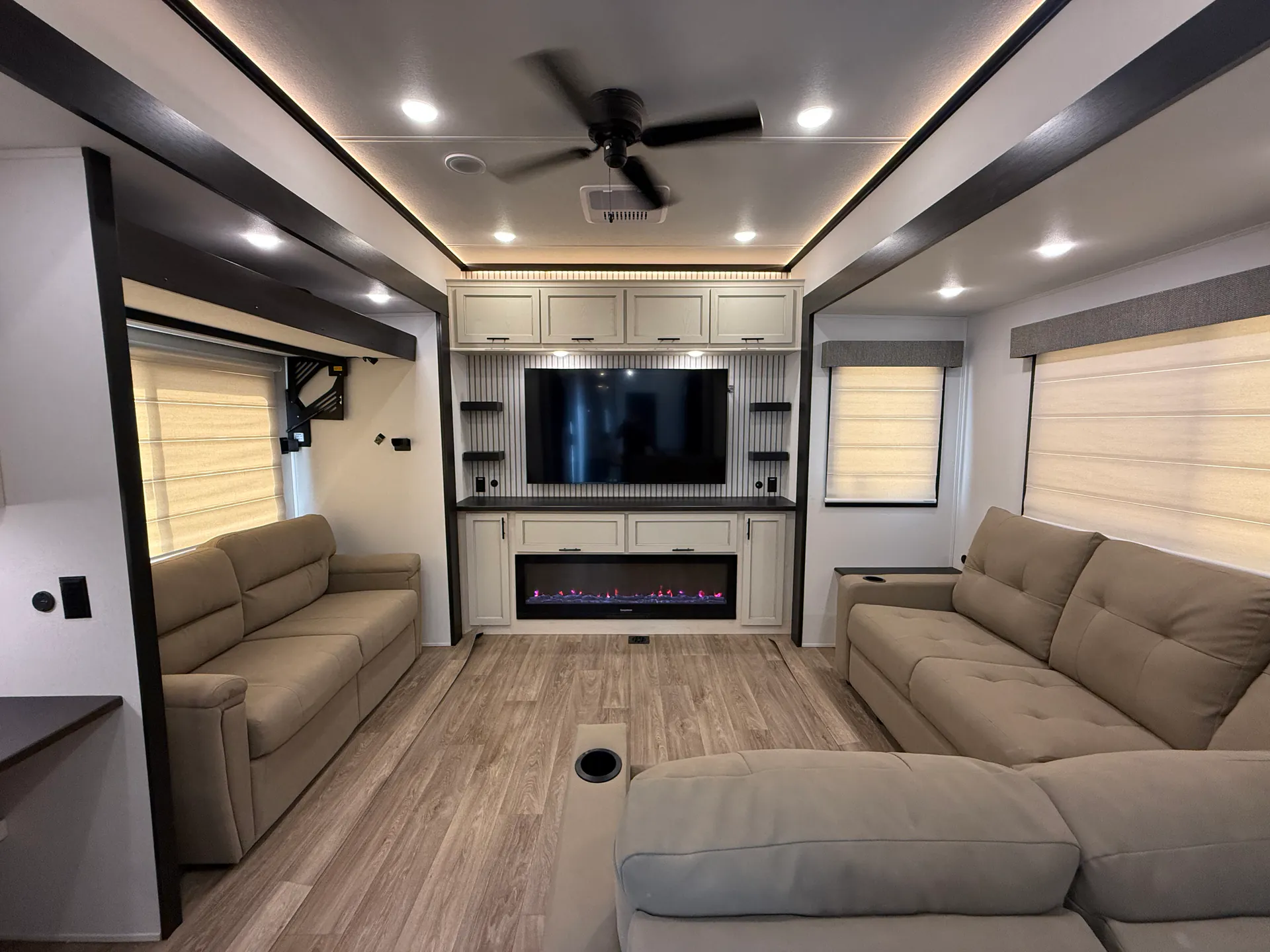 2027 Forest River Sabre 38RVHUNTER — Fifth wheel living room with opposing sofas, entertainment center, fireplace, and windows