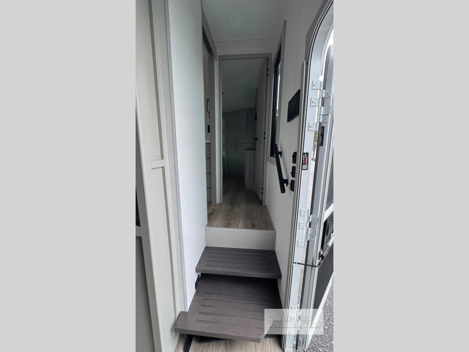 2026 Brinkley Model G 3950 — Fifth-wheel entry steps lead through a narrow interior hallway toward cabinetry and an interior doorway
