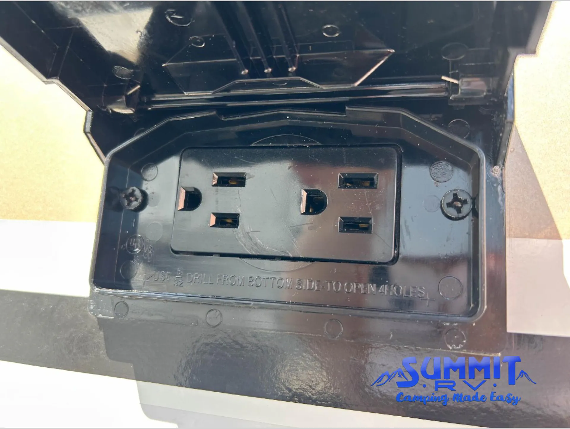 2027 Jayco Eagle 355MBQS — Close-up visibly shows an exterior-installed electrical receptacle in a protective cover