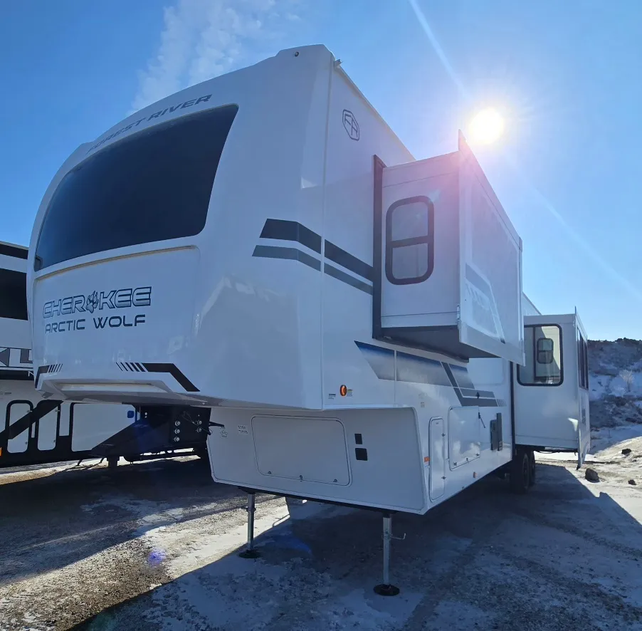 2026 Forest River Arctic Wolf 38LEAH.G — Exterior photograph clearly shows the Arctic Wolf fifth-wheel shell, hitch area, slide-outs, and landing gear