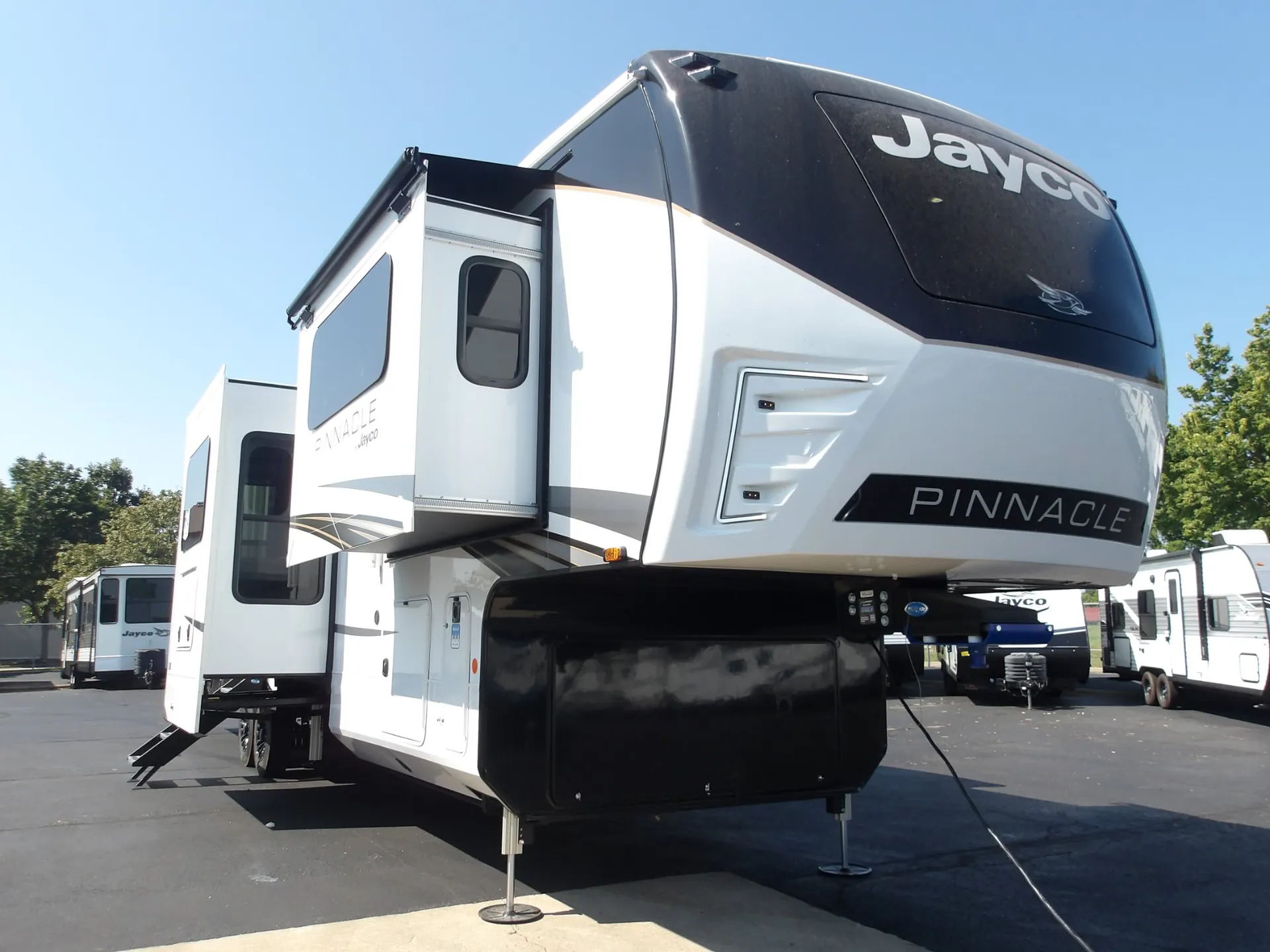 2027 Jayco Pinnacle 39FLOK — The exterior front and side of a Jayco Pinnacle fifth-wheel RV
