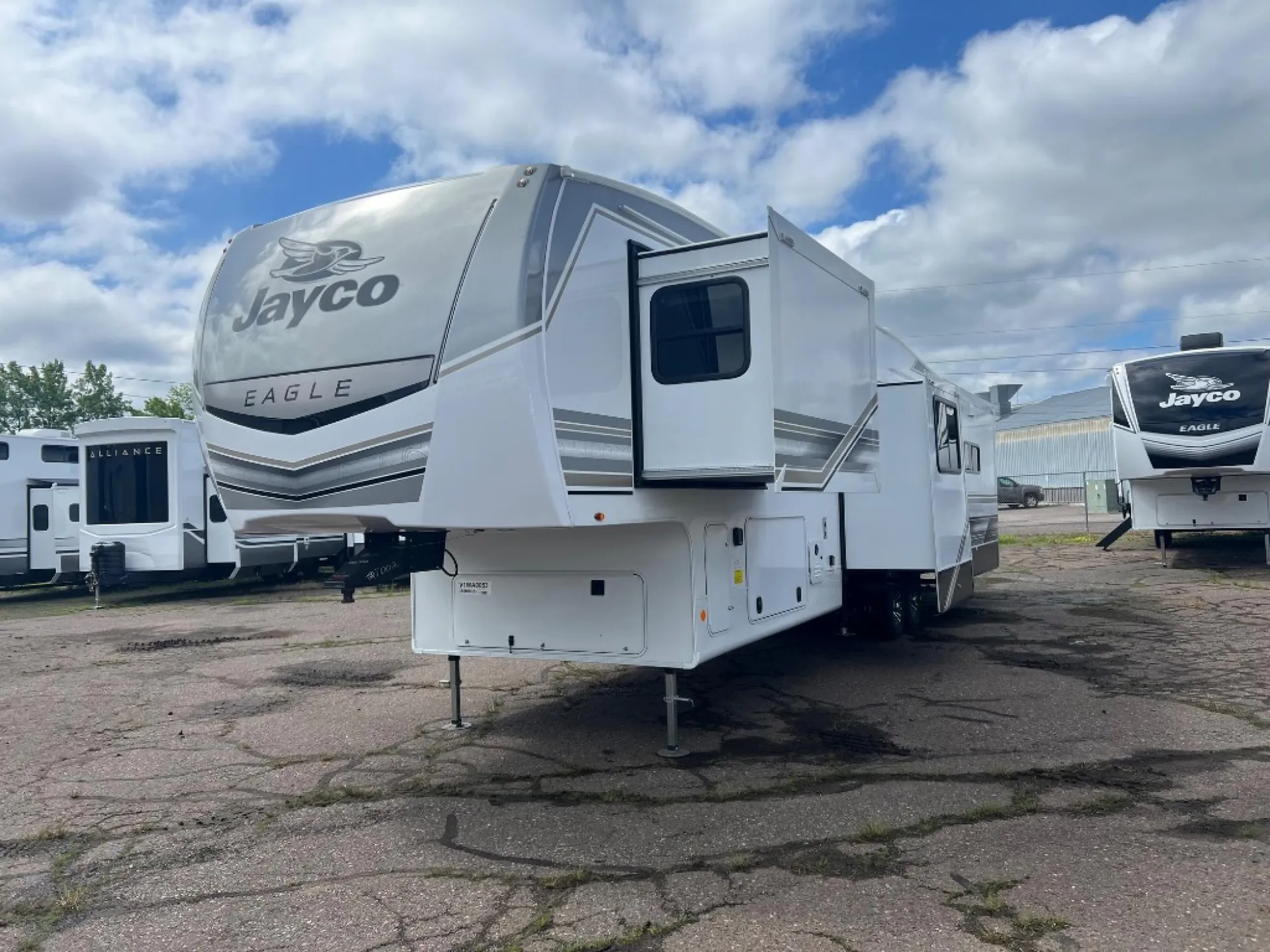 2027 Jayco Eagle 355MBQS — The exterior front, hitch area, slide-outs, and side of the fifth-wheel RV