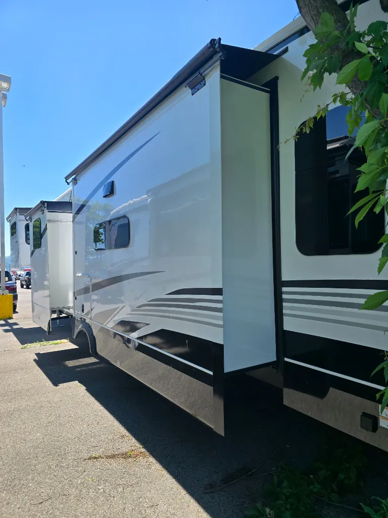 2026 Jayco North Point 377RLBH — Exterior side view visibly shows the RV shell, slide-outs, windows, wheels, and graphics