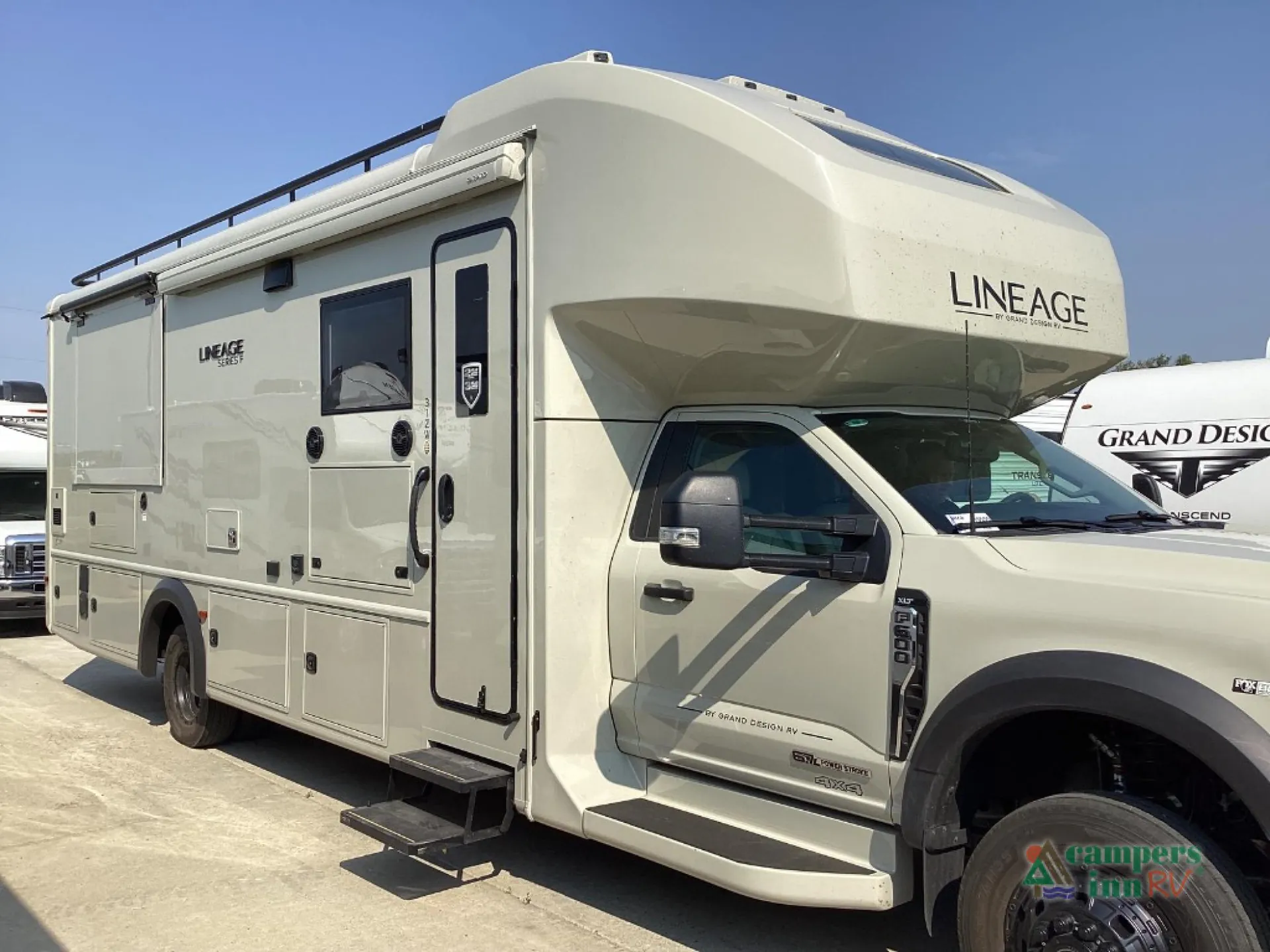 2027 Grand Design Lineage Series F 31ZW — The exterior side and front of the Lineage motorhome, including body shell, entry door, awning, and cab