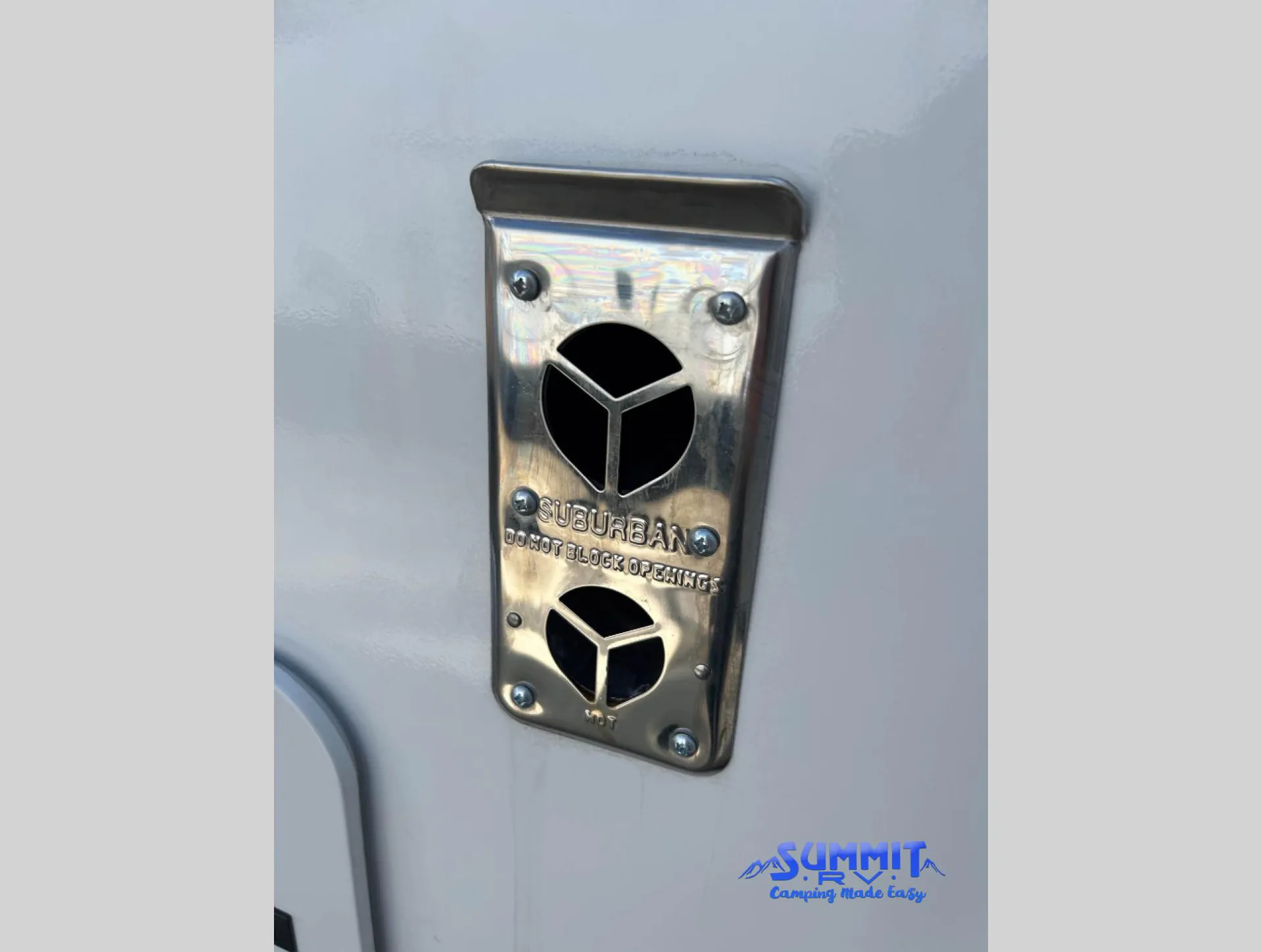 2027 Jayco Eagle 355MBQS — Close-up visibly shows an exterior Suburban component labeled DO NOT BLOCK OPENING, consistent with installed utility equipment