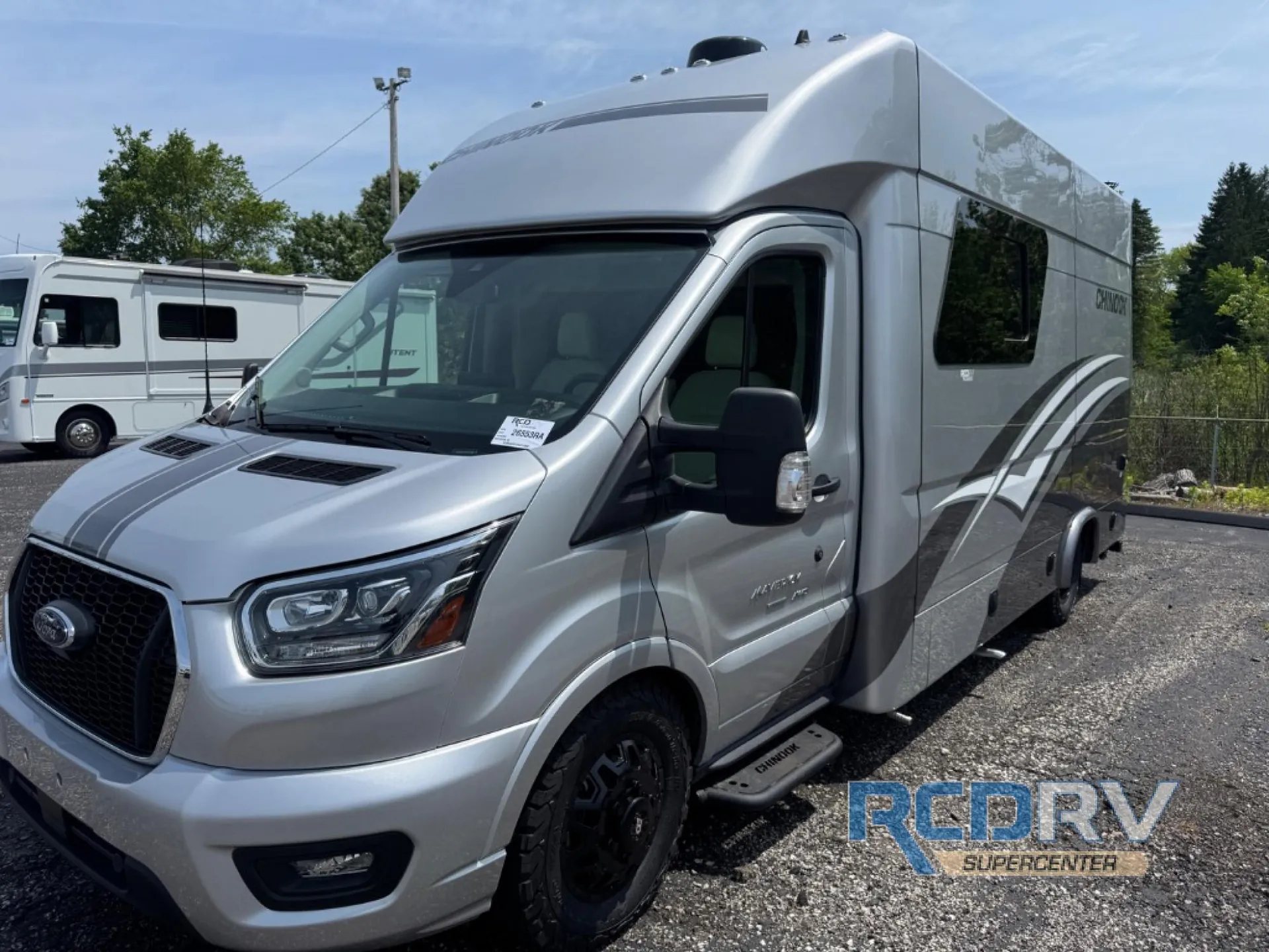 2025 Chinook RV Maverick SS — Exterior front-side photograph visibly shows the RV body, cab, wheel, side window, and graphics