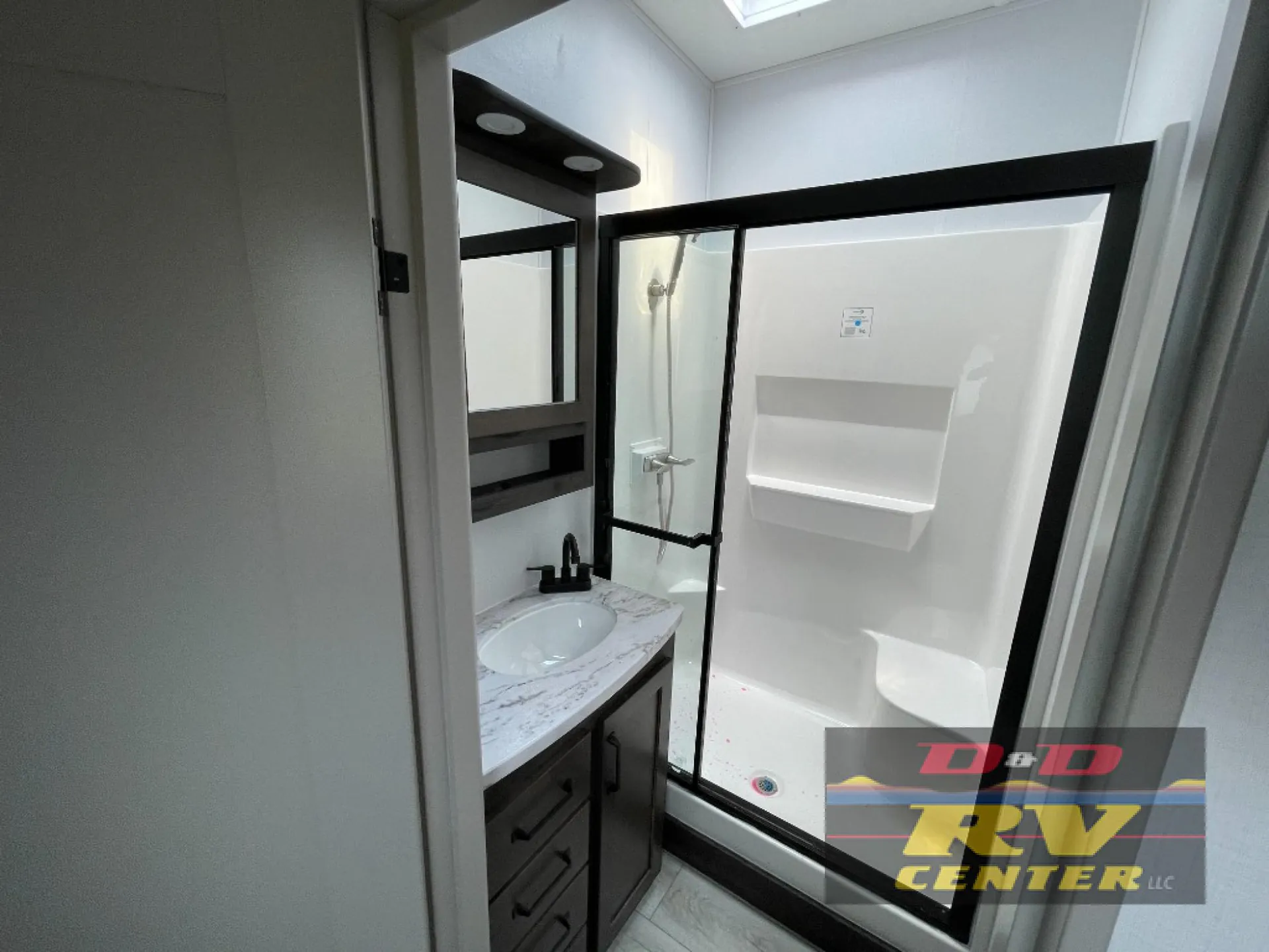 2026 Keystone Montana High Country 377FL — Bathroom showing a vanity with sink and a large glass-enclosed shower with built-in shelving