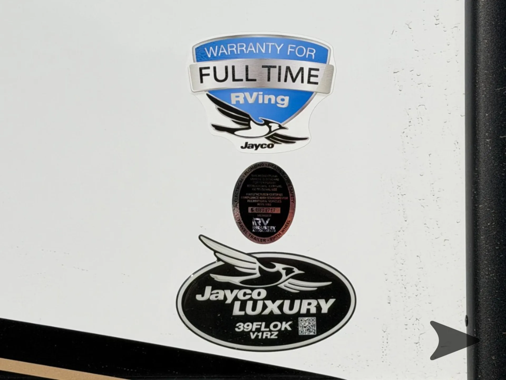 2027 Jayco Pinnacle 39FLOK — Manufacturer and model badges mounted on the RV's exterior wall