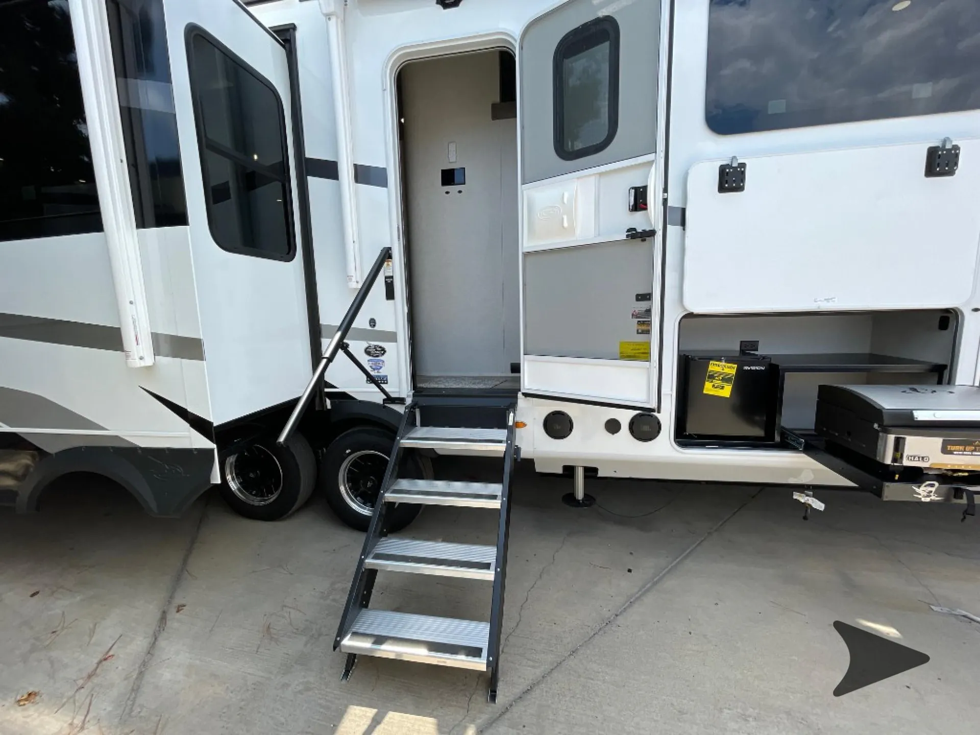 2026 Jayco North Point 377RLBH — Wide photograph visibly shows the RV exterior, entry door, steps, wheels, and exterior compartments