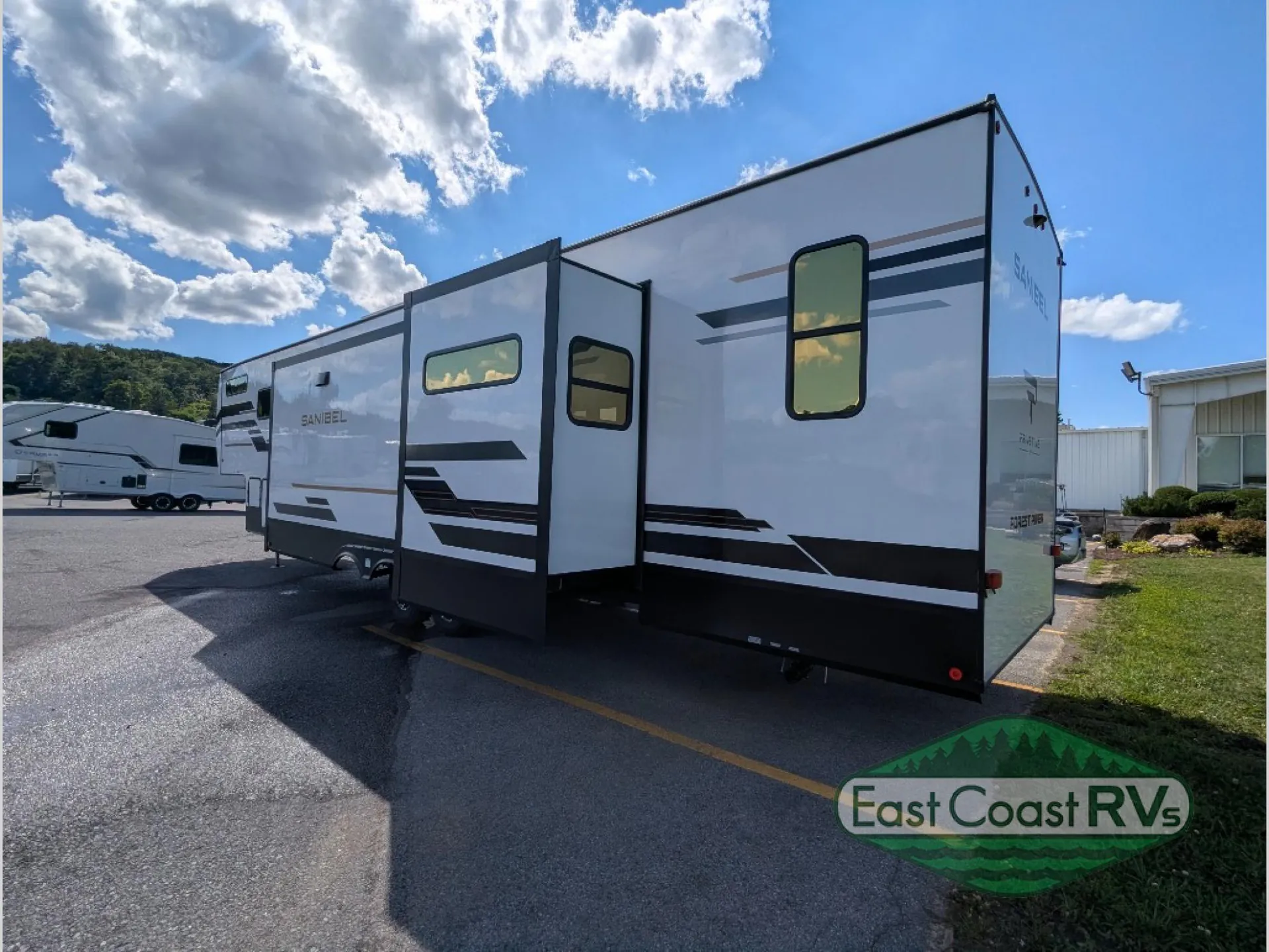 2027 Forest River Sanibel 40BUNK — The outside rear/side of a Sanibel fifth-wheel RV with slide-outs