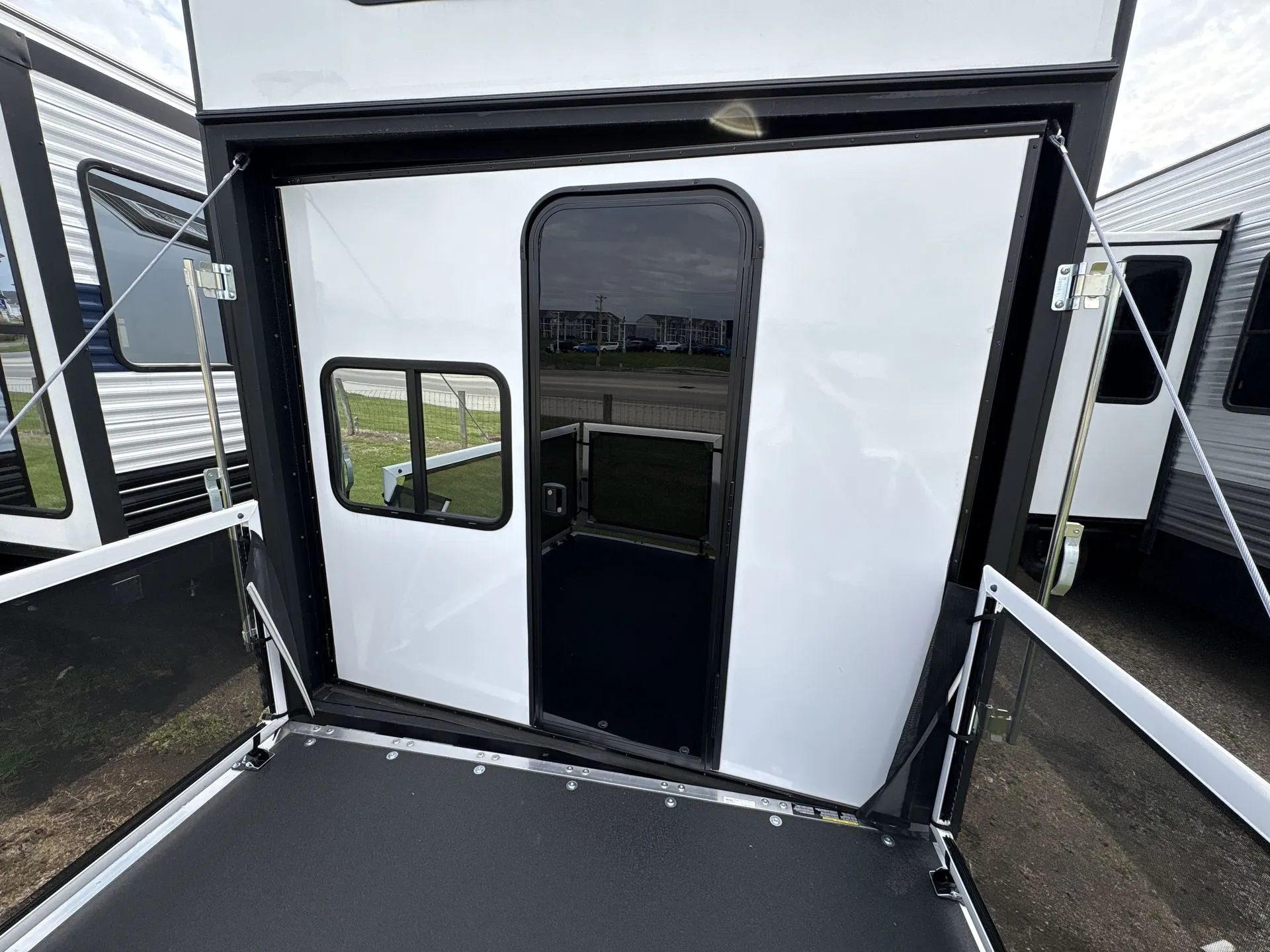2026 Forest River Cherokee Wolf Pack 397STAY — Open rear cargo ramp and exterior-facing cargo enclosure are visibly shown