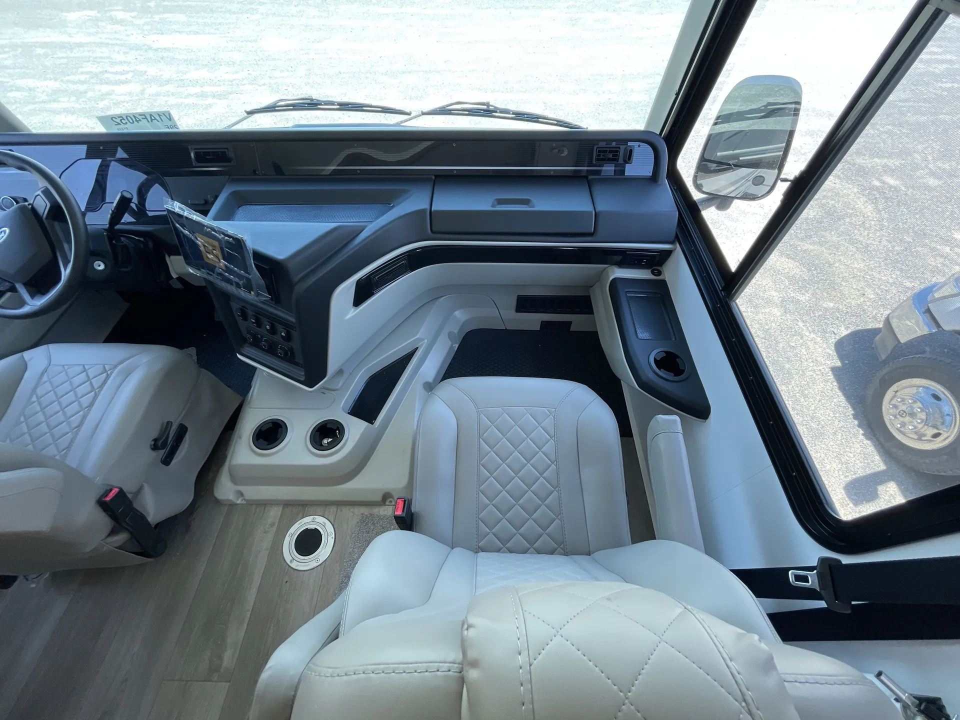 2027 Jayco Alante 29F — Passenger-side Class A cockpit with dashboard, infotainment screen, passenger seat, storage compartments, and windshield