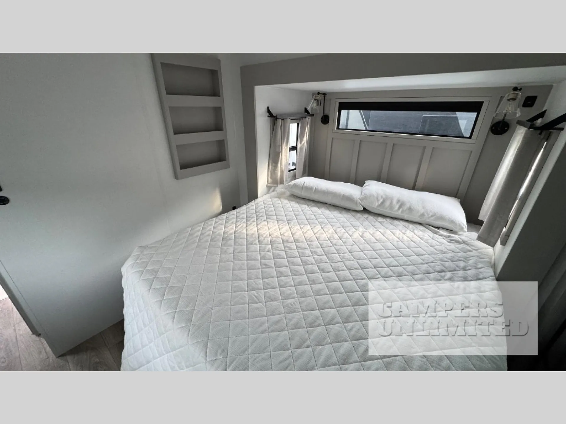 2026 Brinkley Model G 3950 — Enclosed bedroom with a large made bed, pillows, bedside shelves, windows, and curtains