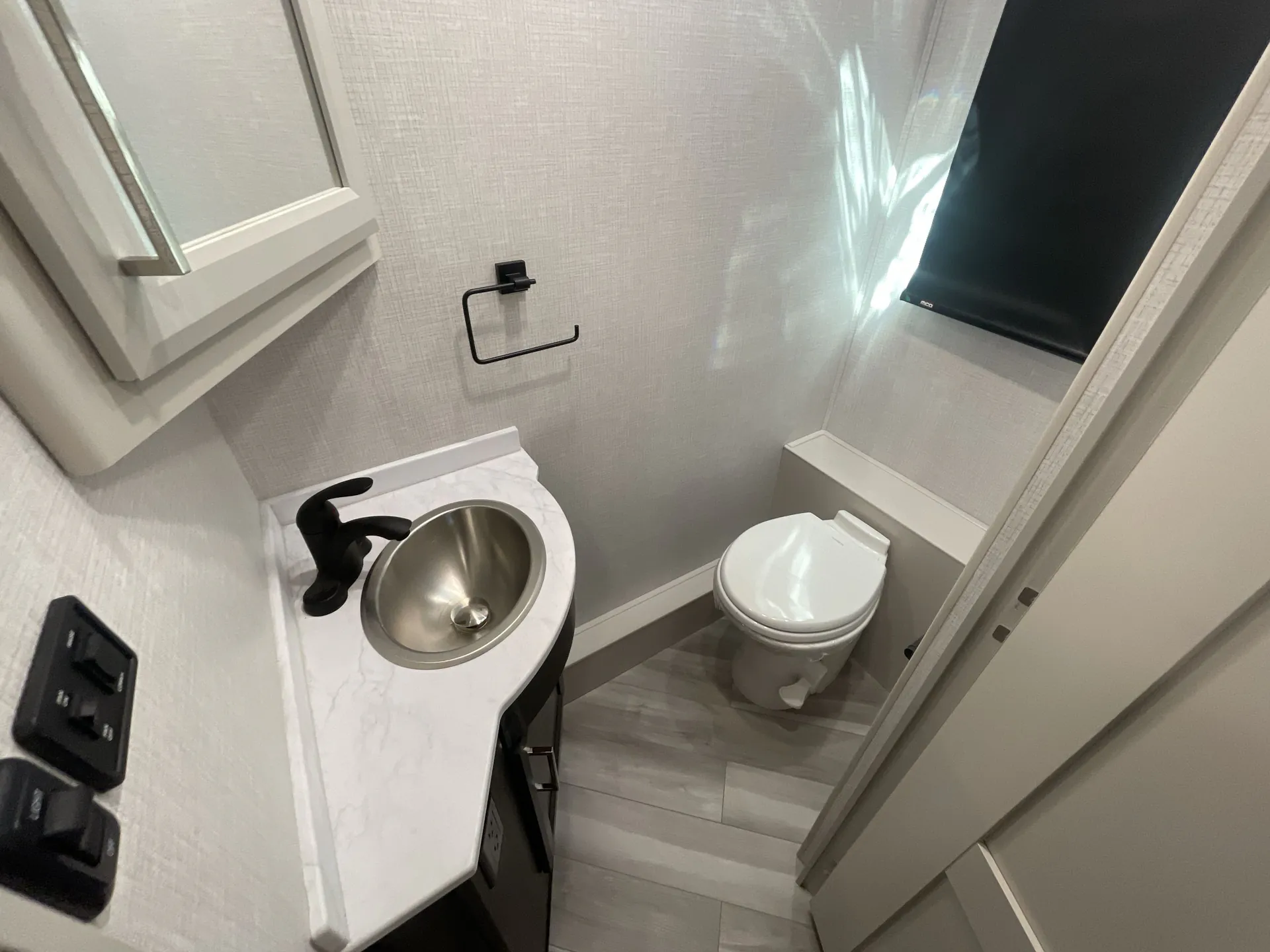 2026 Holiday Rambler Invicta 36Y — Class A bathroom with a round sink vanity, toilet, mirror, and window