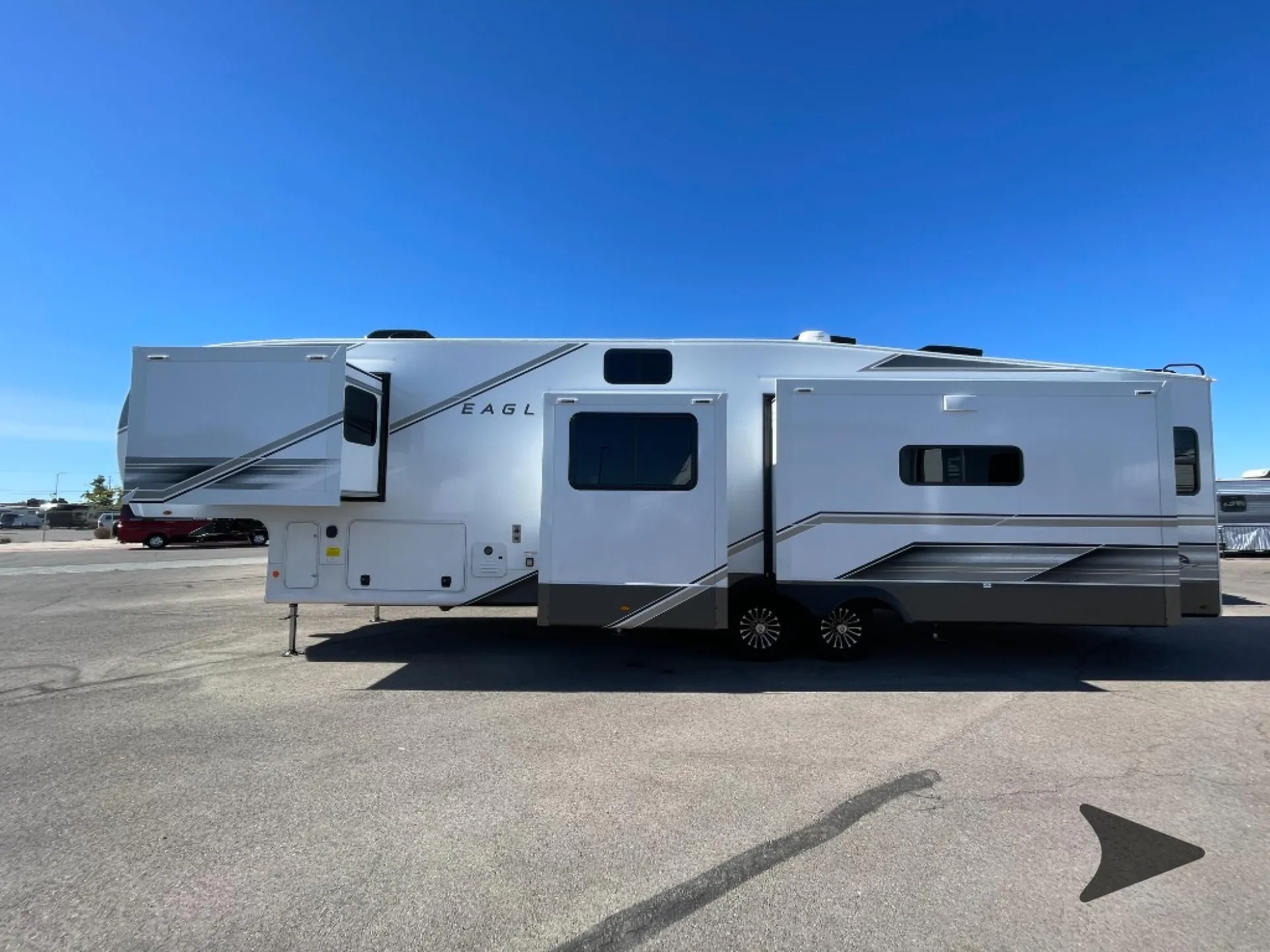 2027 Jayco Eagle 355MBQS — Visible broad side exterior photograph of the fifth-wheel, including slide-outs, wheels, windows, and entry door