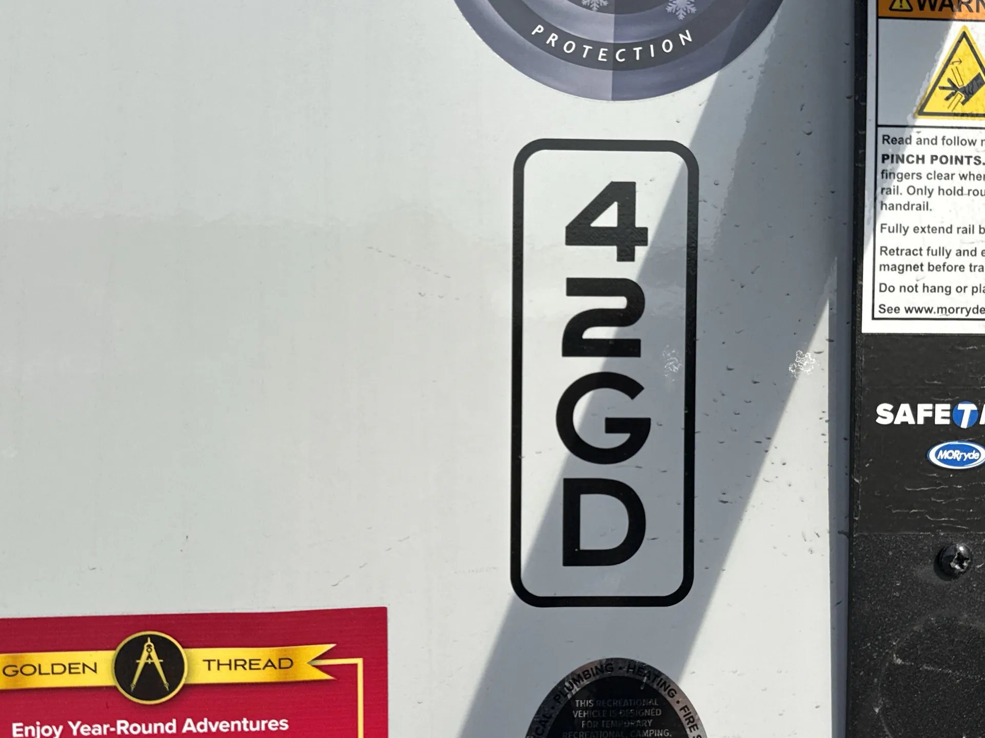 2026 Grand Design Foundation 42GD — Visible exterior wall branding and safety labels on the RV