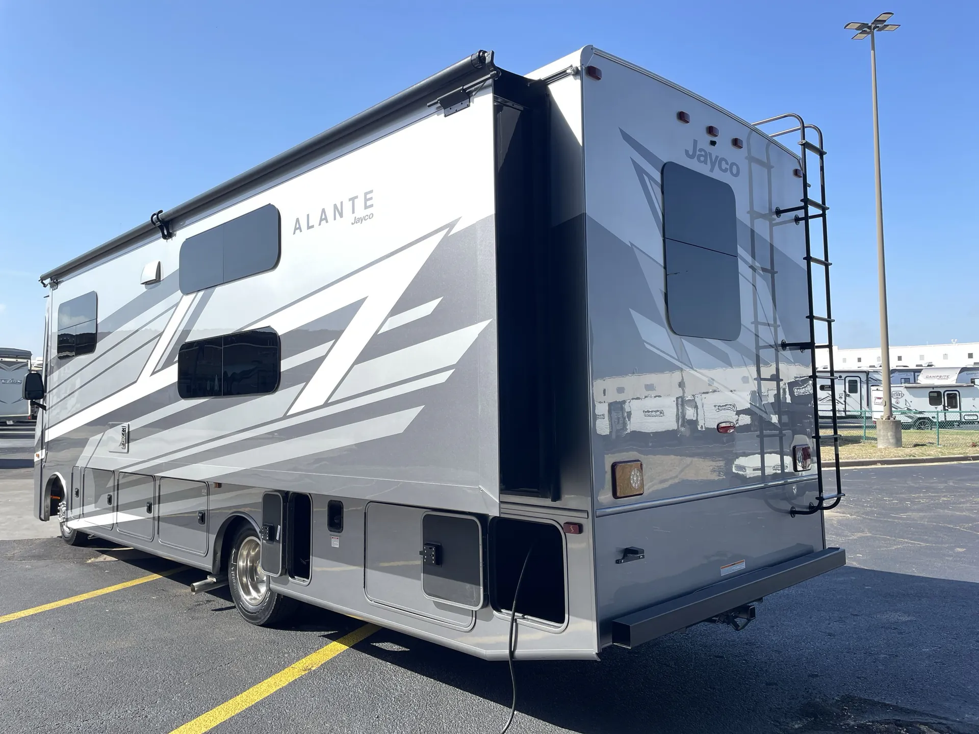 2027 Jayco Alante 29F — Exterior rear-side photograph visibly includes multiple open and closed lower cargo/storage compartments
