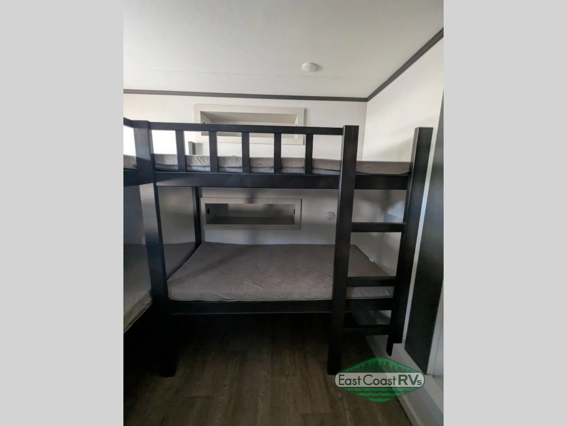 2027 Forest River Sanibel 40BUNK — Bunk sleeping platform with ladder, guardrails, lower mattress, and open floor beneath
