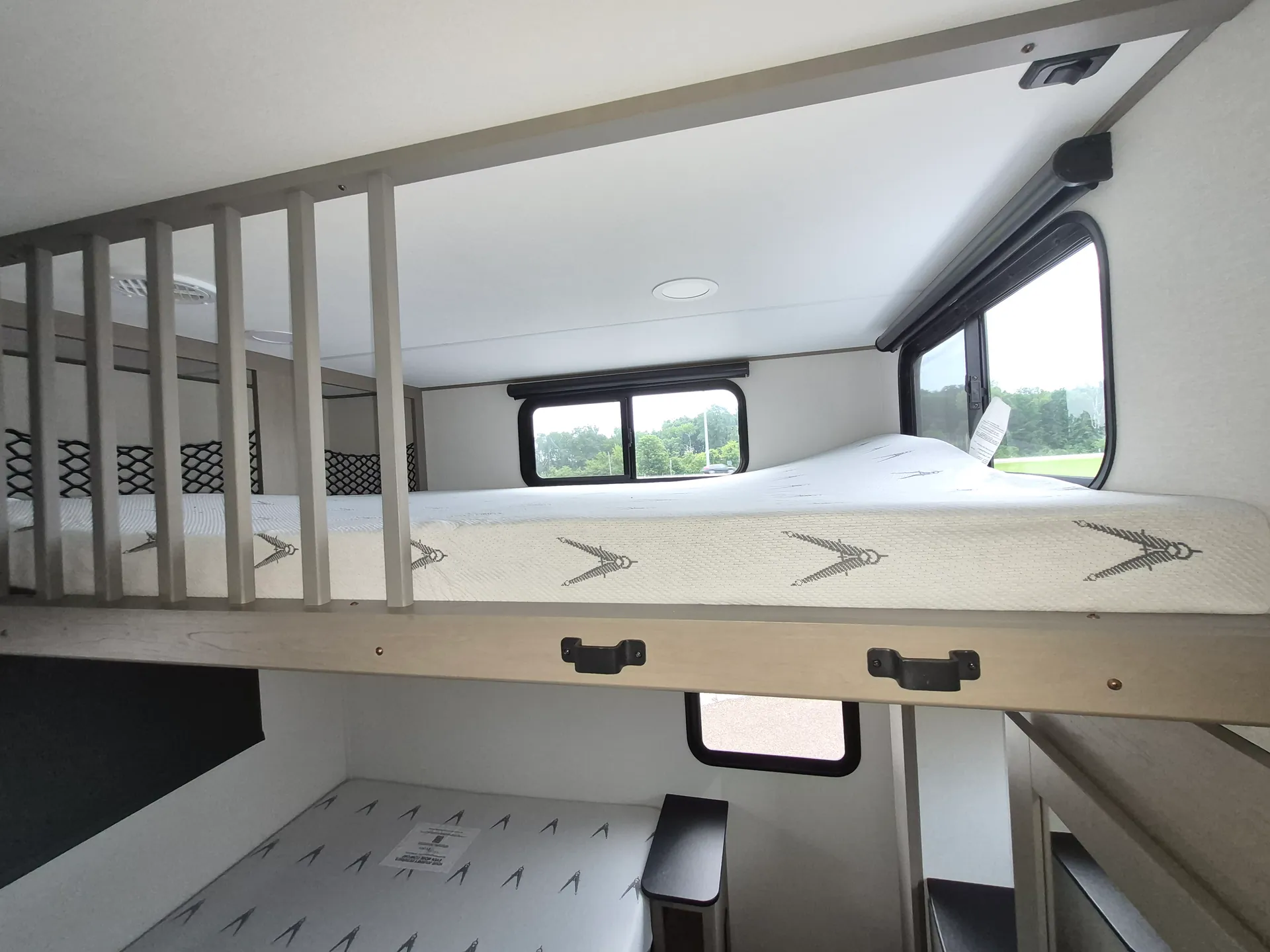 2027 Grand Design Reflection 362TBS — Elevated loft mattress above a lower sleeping surface, separated by safety rails and accessed beside stairs