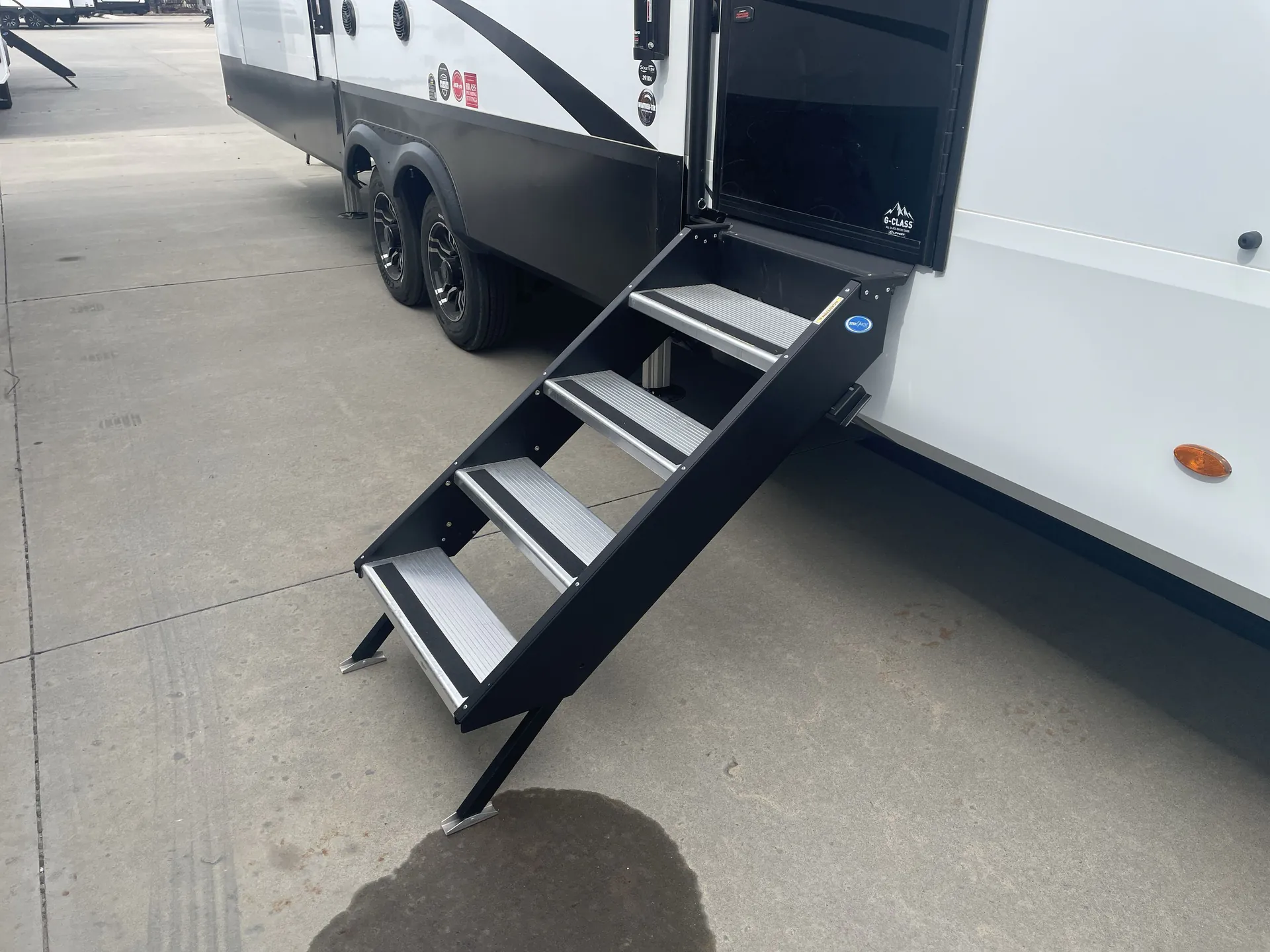 2026 Grand Design Solitude 391DL — The RV exterior entry area and deployed steps