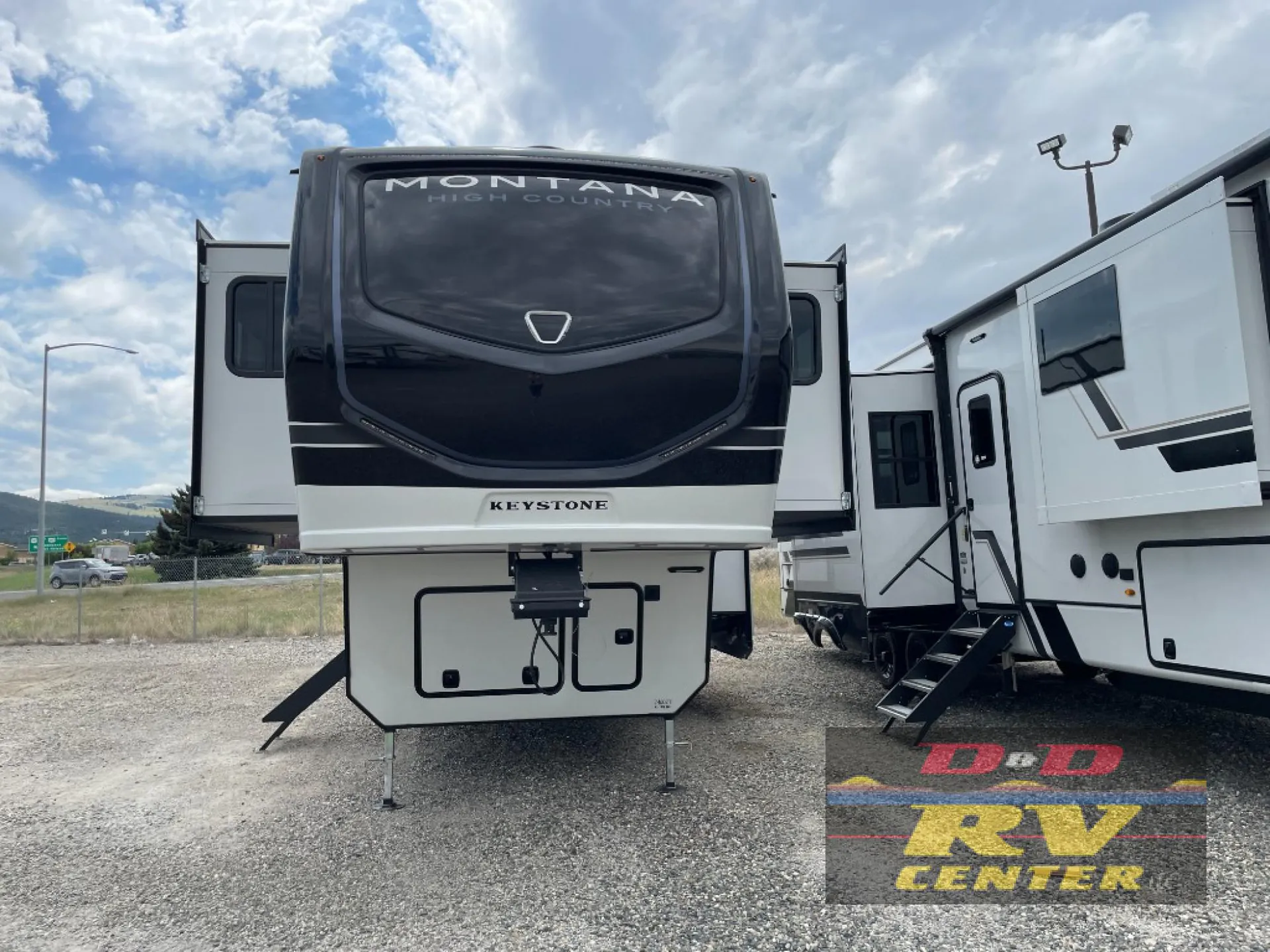 2026 Keystone Montana High Country 377FL — The front exterior cap, fifth-wheel hitch area, landing gear, and slide-outs