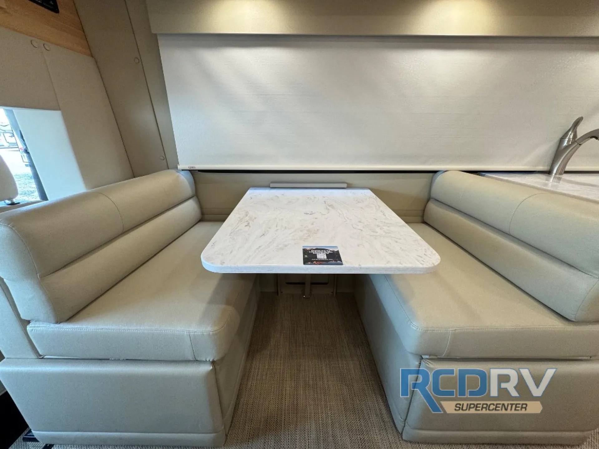 2025 Chinook RV Maverick SS — U-shaped dinette booth with a marble-pattern tabletop and upholstered benches