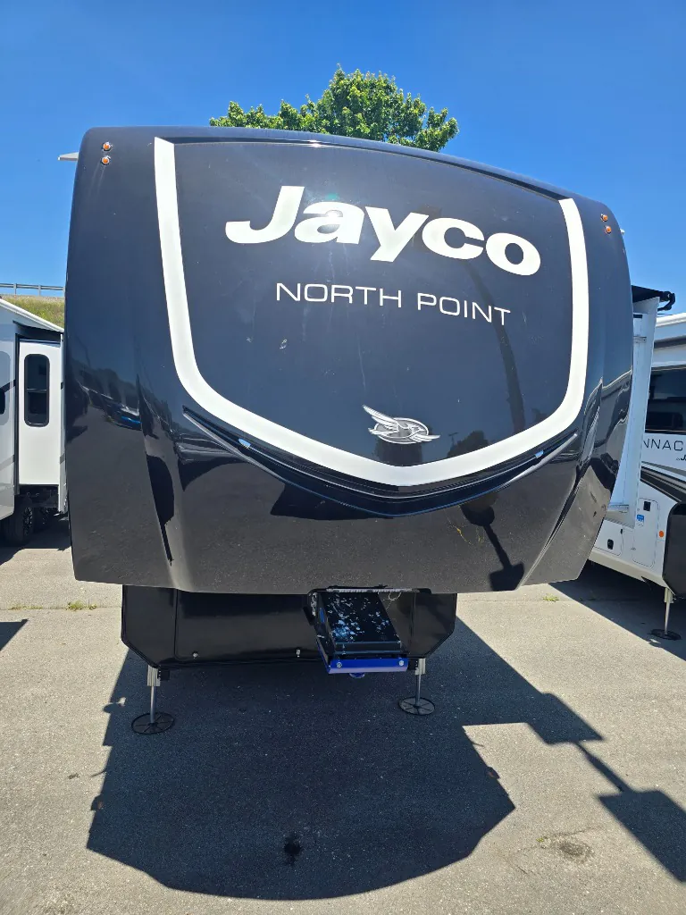 2026 Jayco North Point 377RLBH — Front exterior photograph clearly shows the RV nose, Jayco North Point branding, hitch, and landing legs