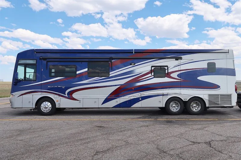 2016 Newmar Dutch Star 4369 — Full side photograph visibly shows the exterior shell, wheels, graphics, windows, awning, and exterior compartments