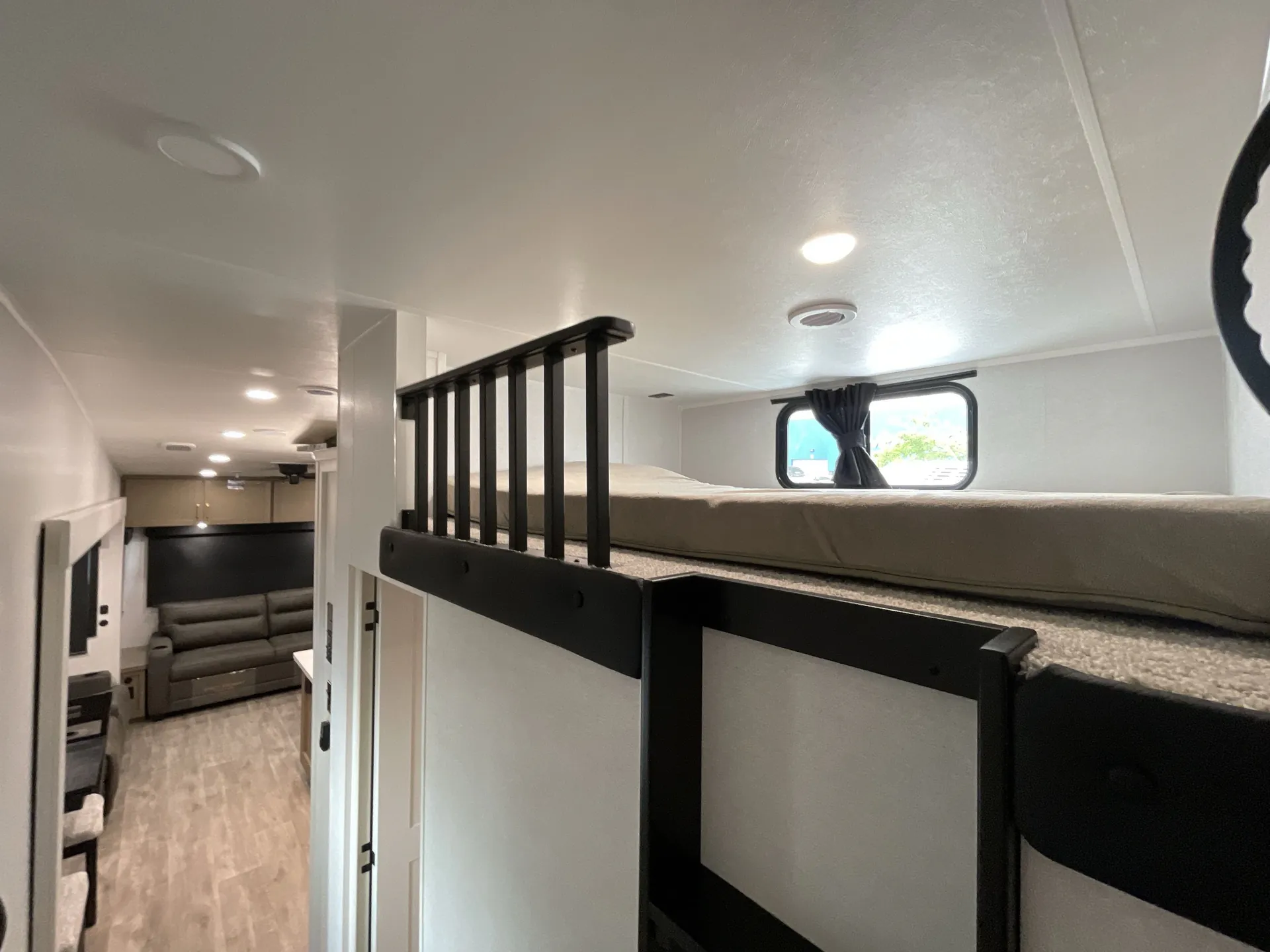 2027 Jayco Eagle 355MBQS — Fifth wheel over-cab loft mattress with safety rail above a visible living area