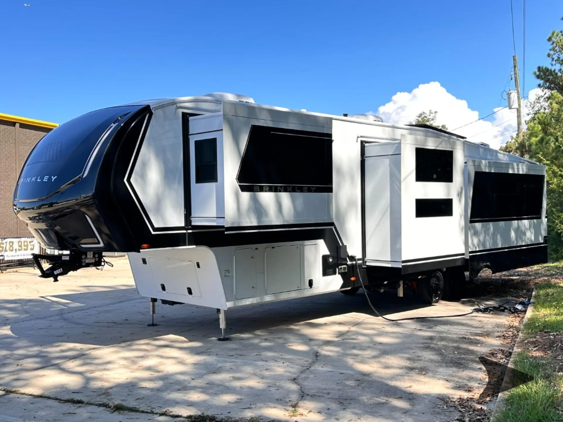 2026 Brinkley Model Z 3610 — Clear photograph of the fifth-wheel RV exterior with slide-outs, hitch, and leveling equipment