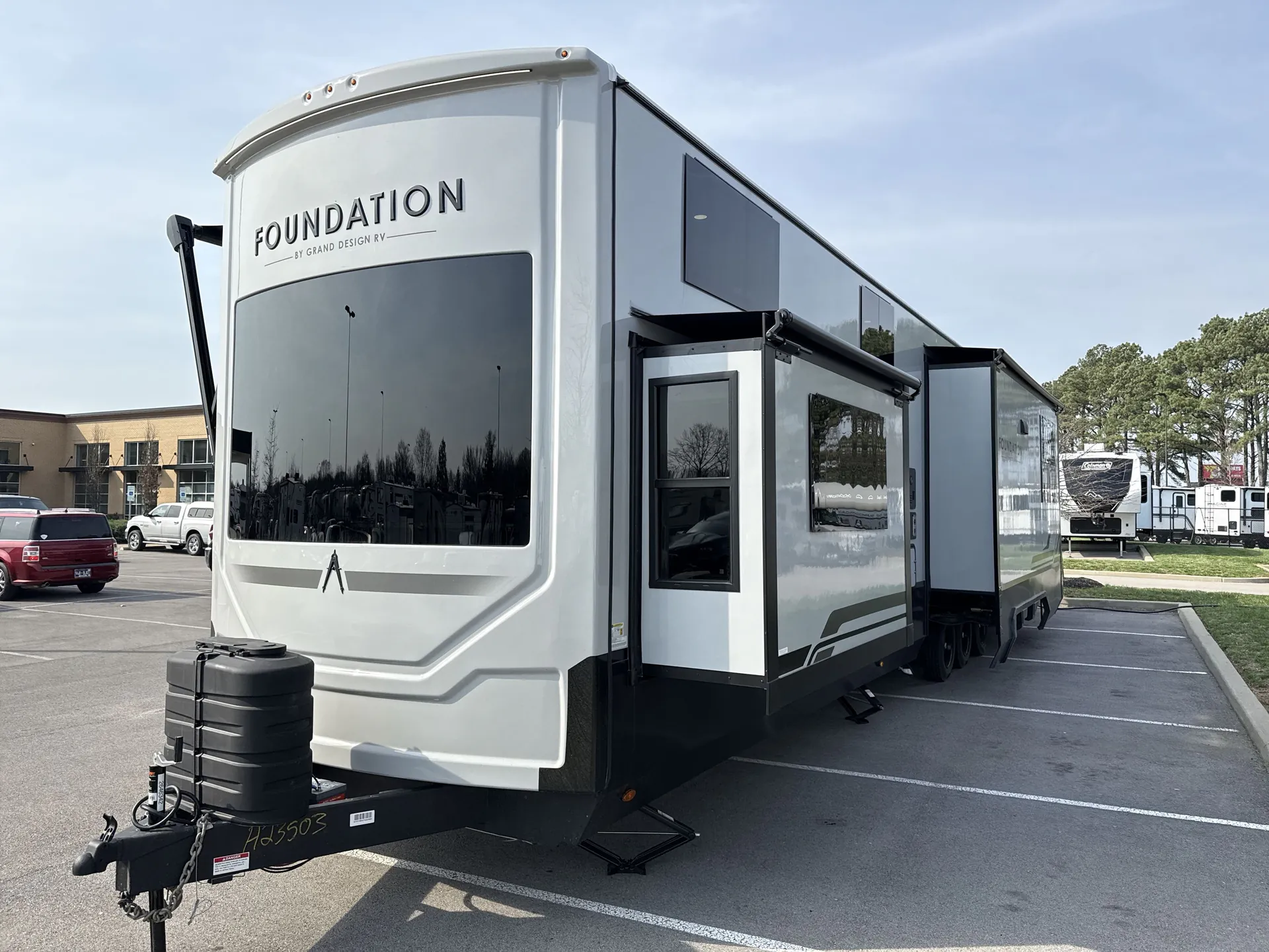 2026 Grand Design Foundation 42GD — Wide photograph clearly shows the complete exterior of the Foundation fifth-wheel RV, including hitch, slides, and awnings