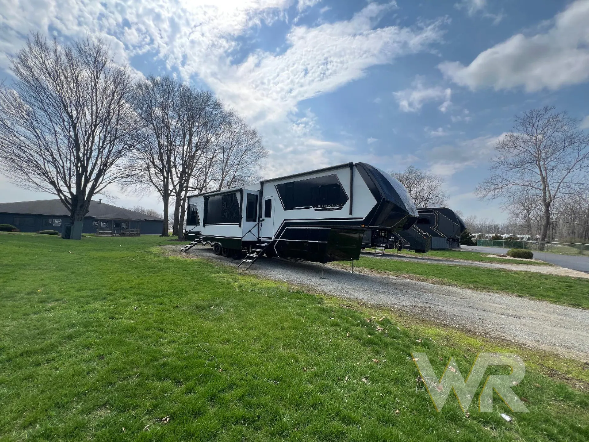 2026 Brinkley Model G 3950 — The outside side of a fifth-wheel RV parked outdoors