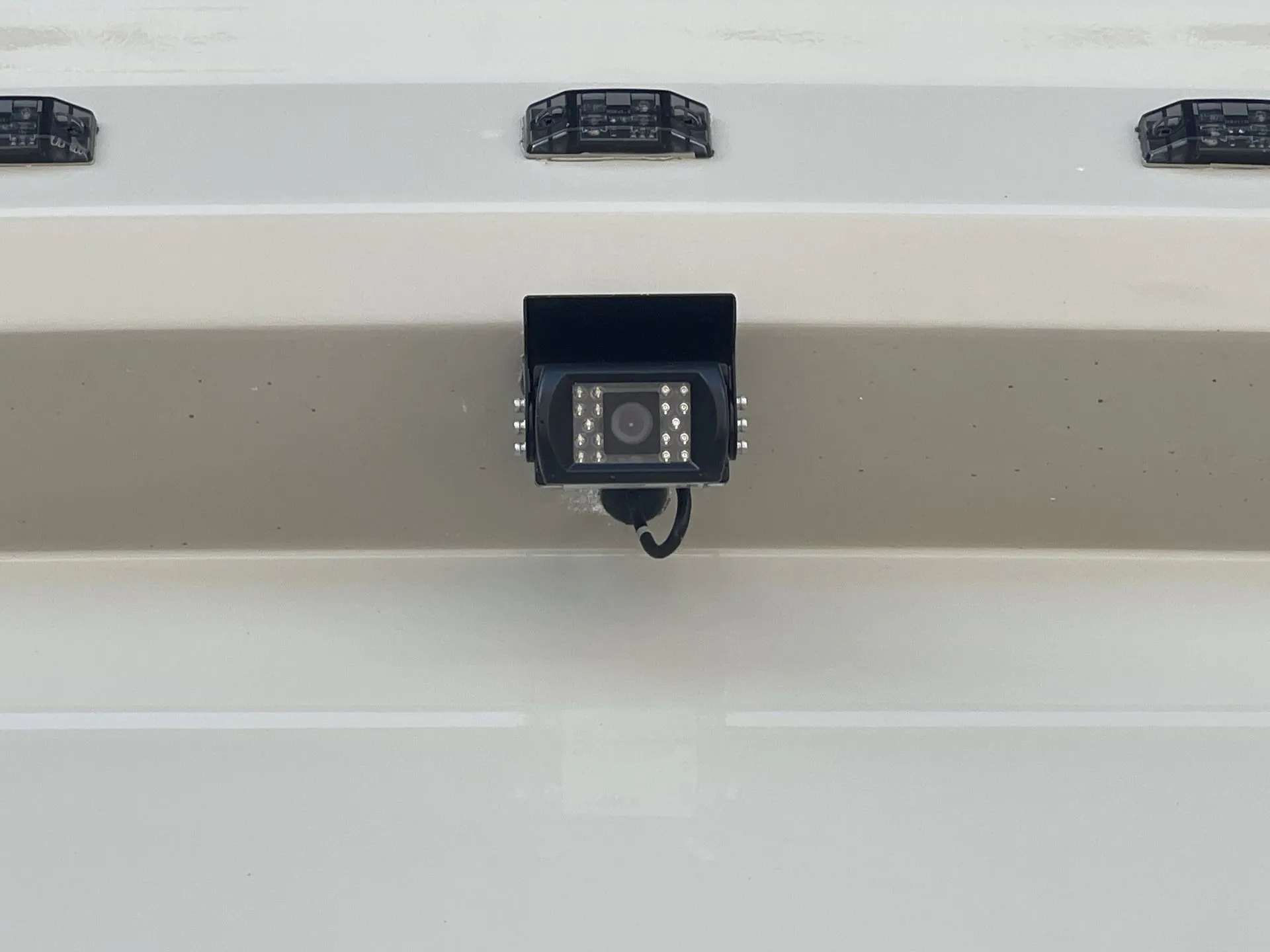 2027 Grand Design Lineage Series F 31ZW — Close-up of a camera and wiring mounted on the RV's exterior body, an exterior-installed monitoring feature