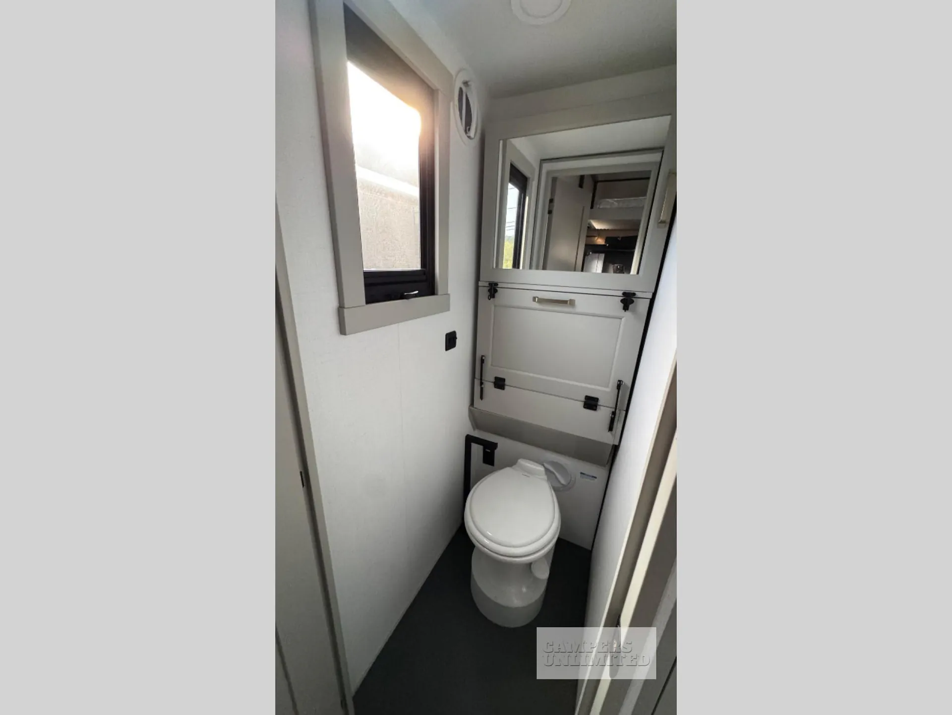 2026 Brinkley Model G 3950 — Narrow bathroom with toilet, small window, mirrored cabinet, and fold-down or latching wall panel