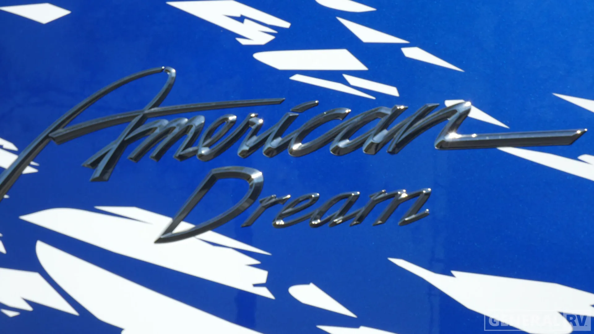2026 American Coach American Dream 45A — Close photograph of exterior RV branding mounted on the painted body